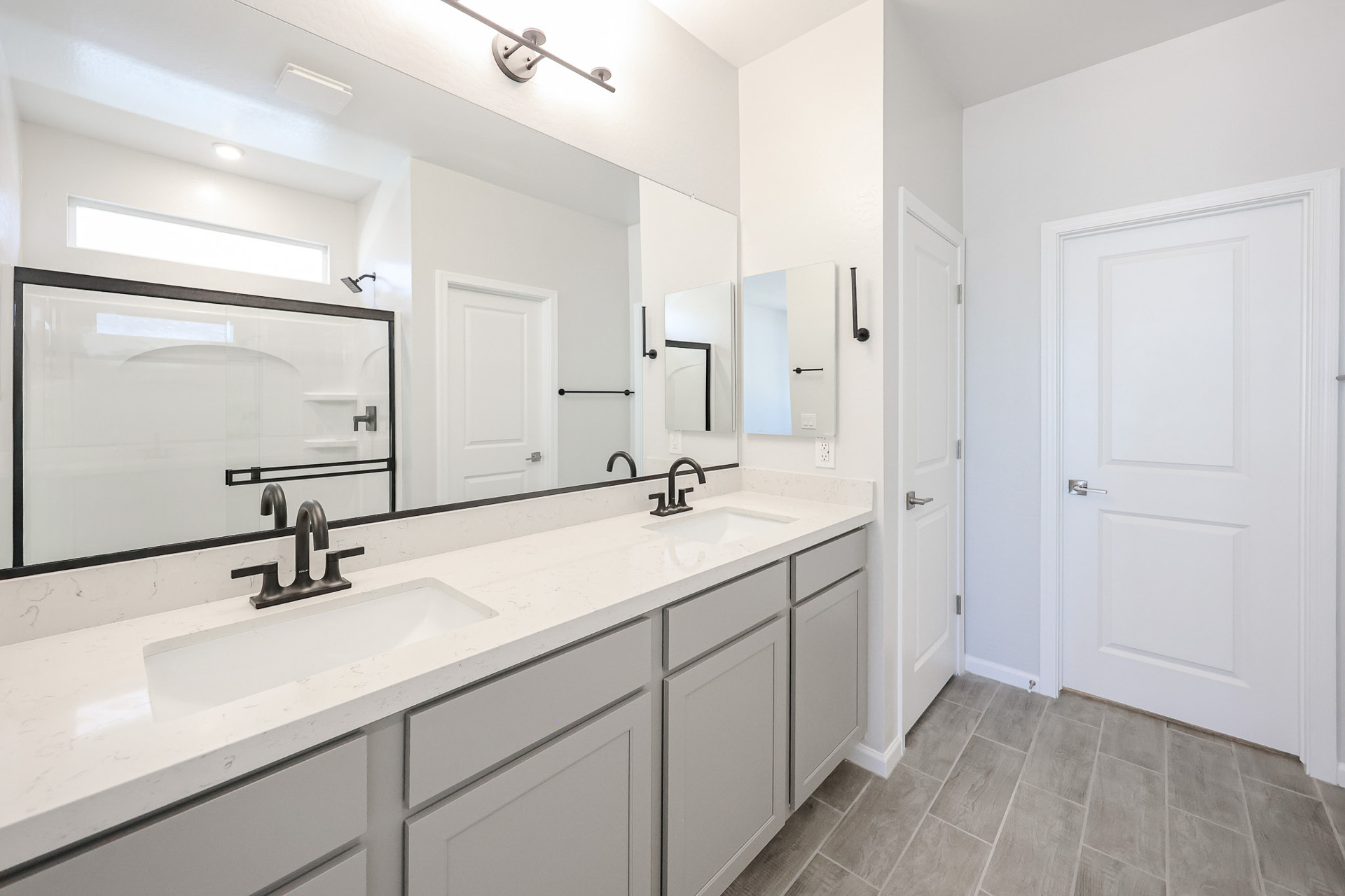 A bathroom with white cabinets.