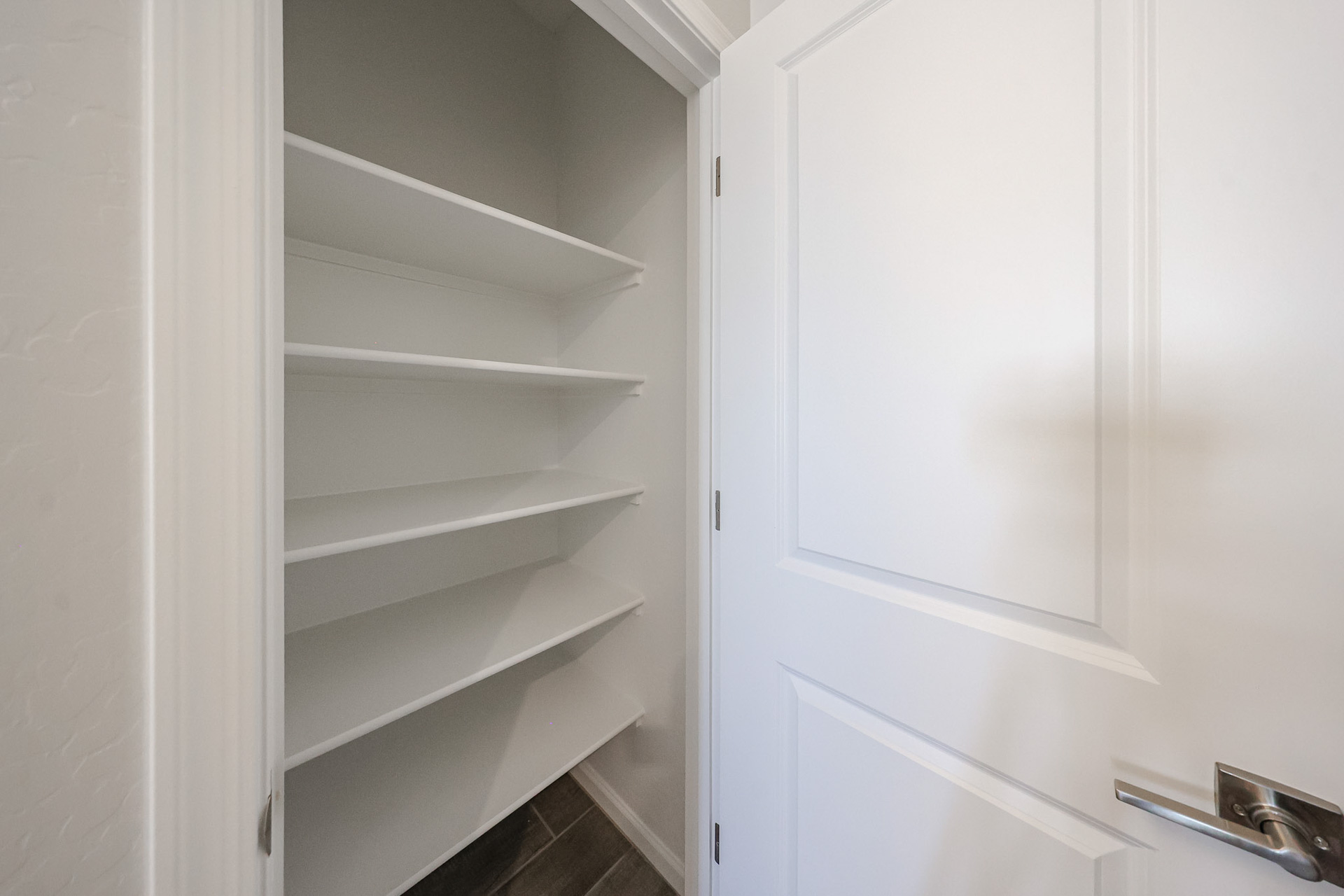 A white closet with white doors.