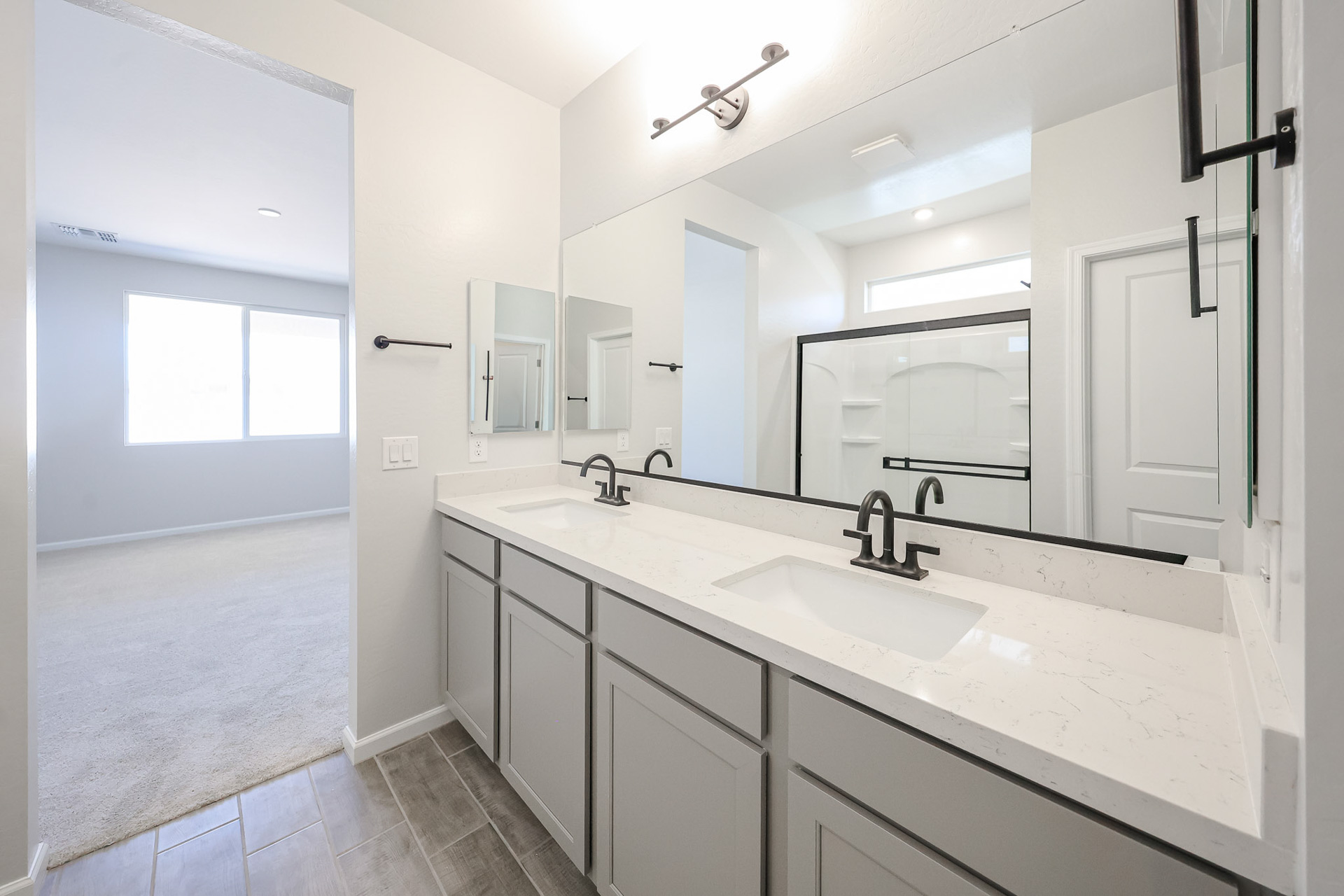 A bathroom with a large mirror.