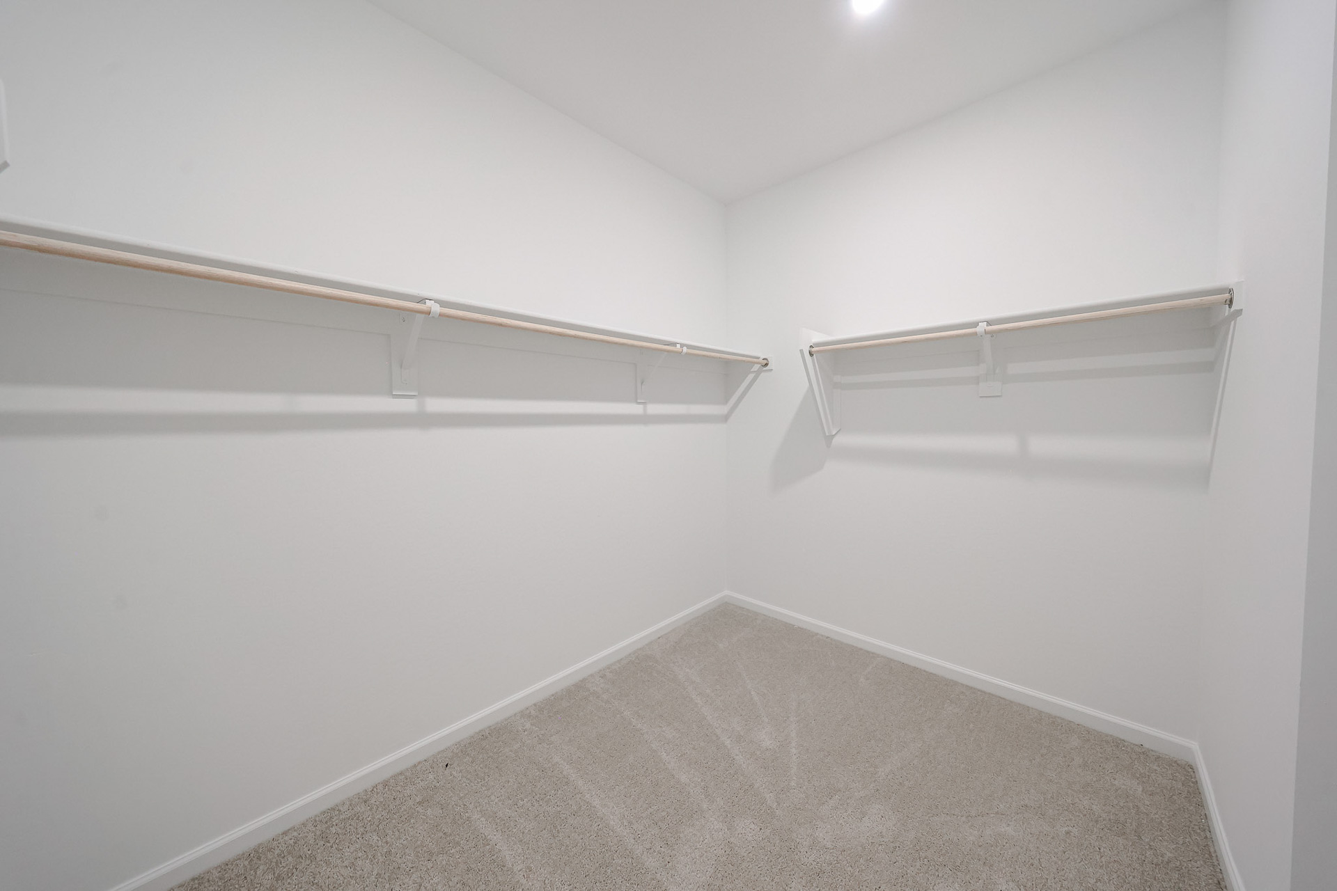 A white wall with a metal railing.