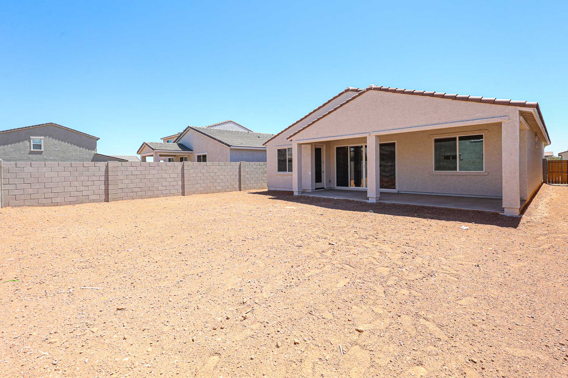 A house in a dirt field.