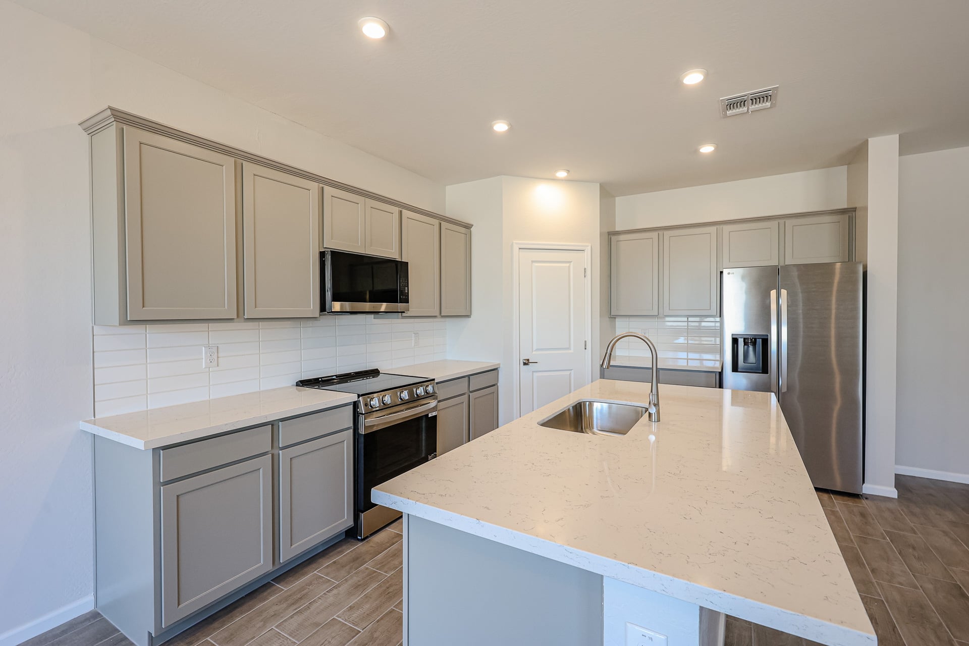 A kitchen with white cabinets.