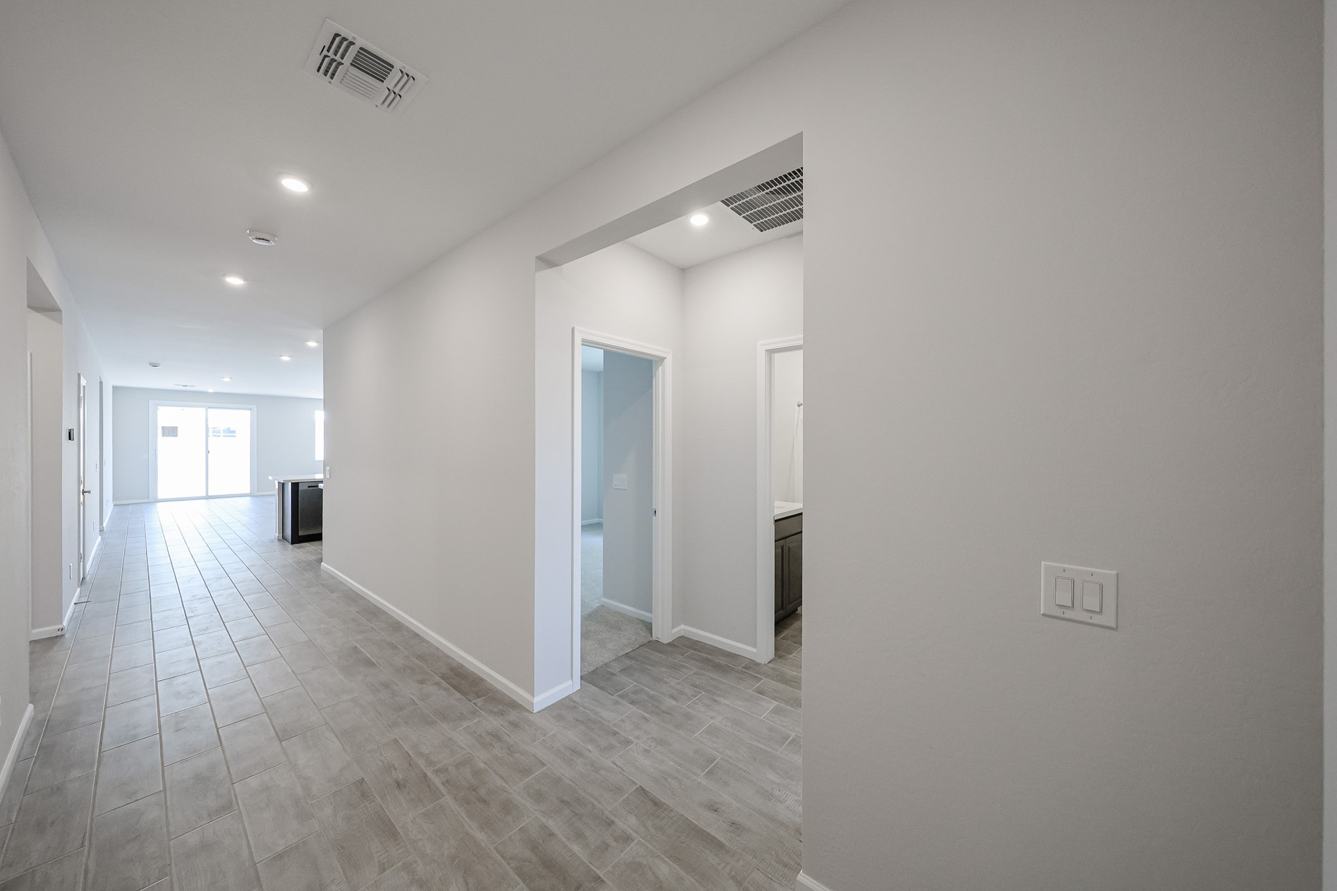 A long hallway with white walls.