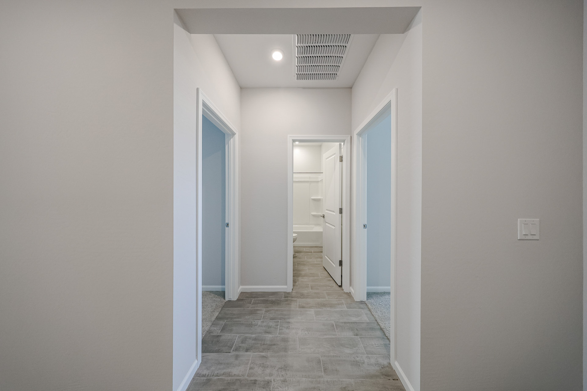 A hallway with white walls.