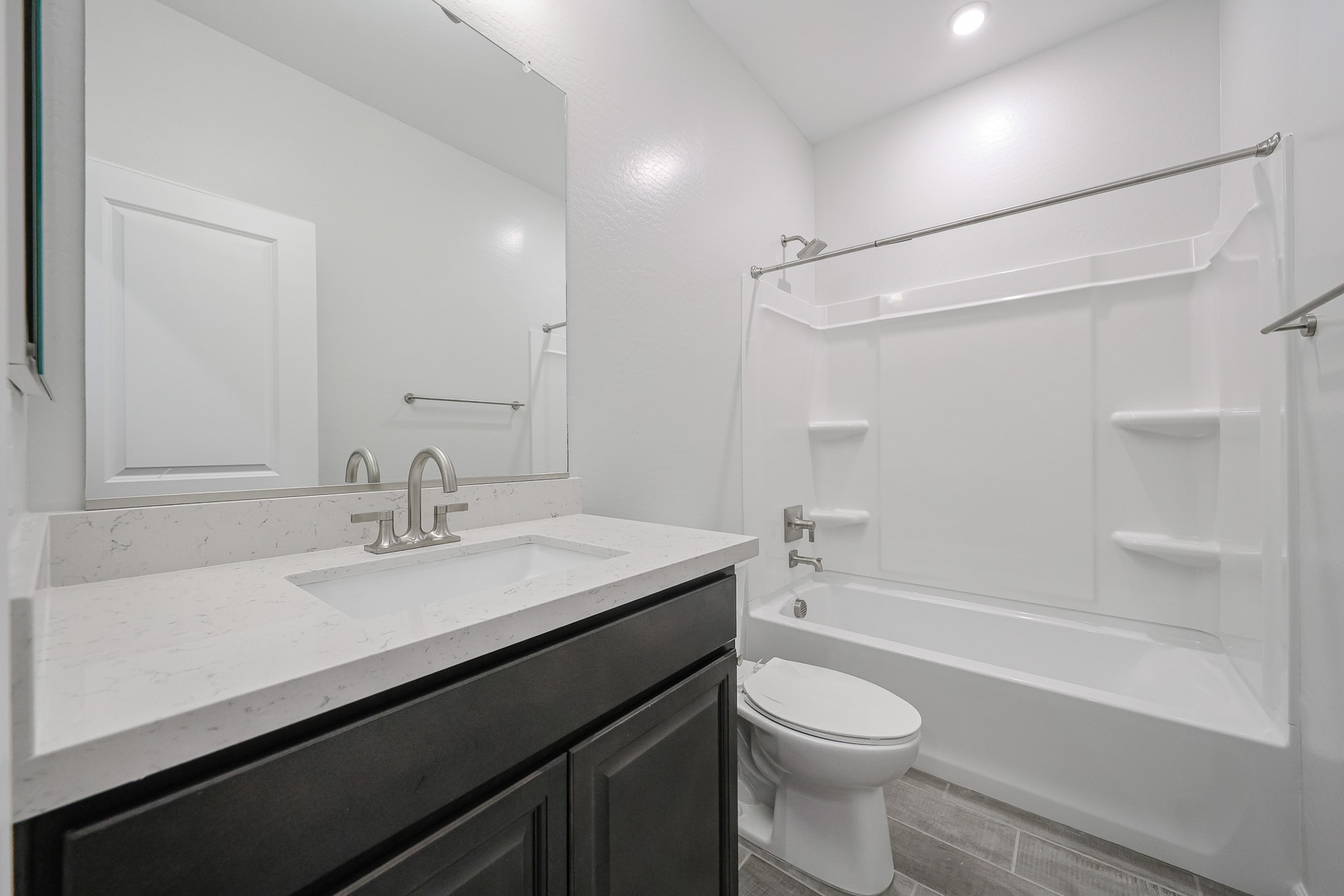 A bathroom with a tub sink and toilet.