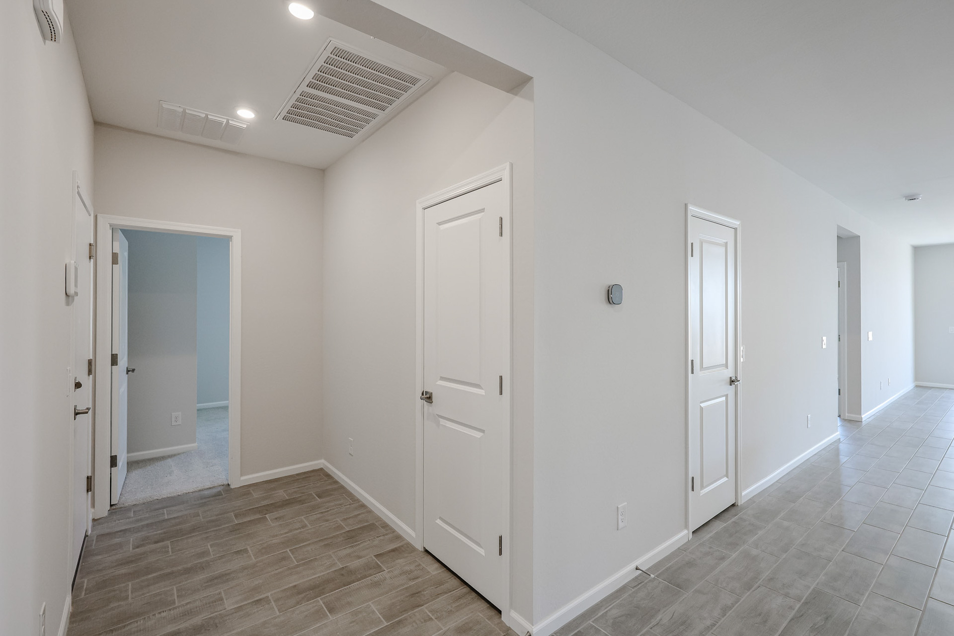A hallway with white doors.