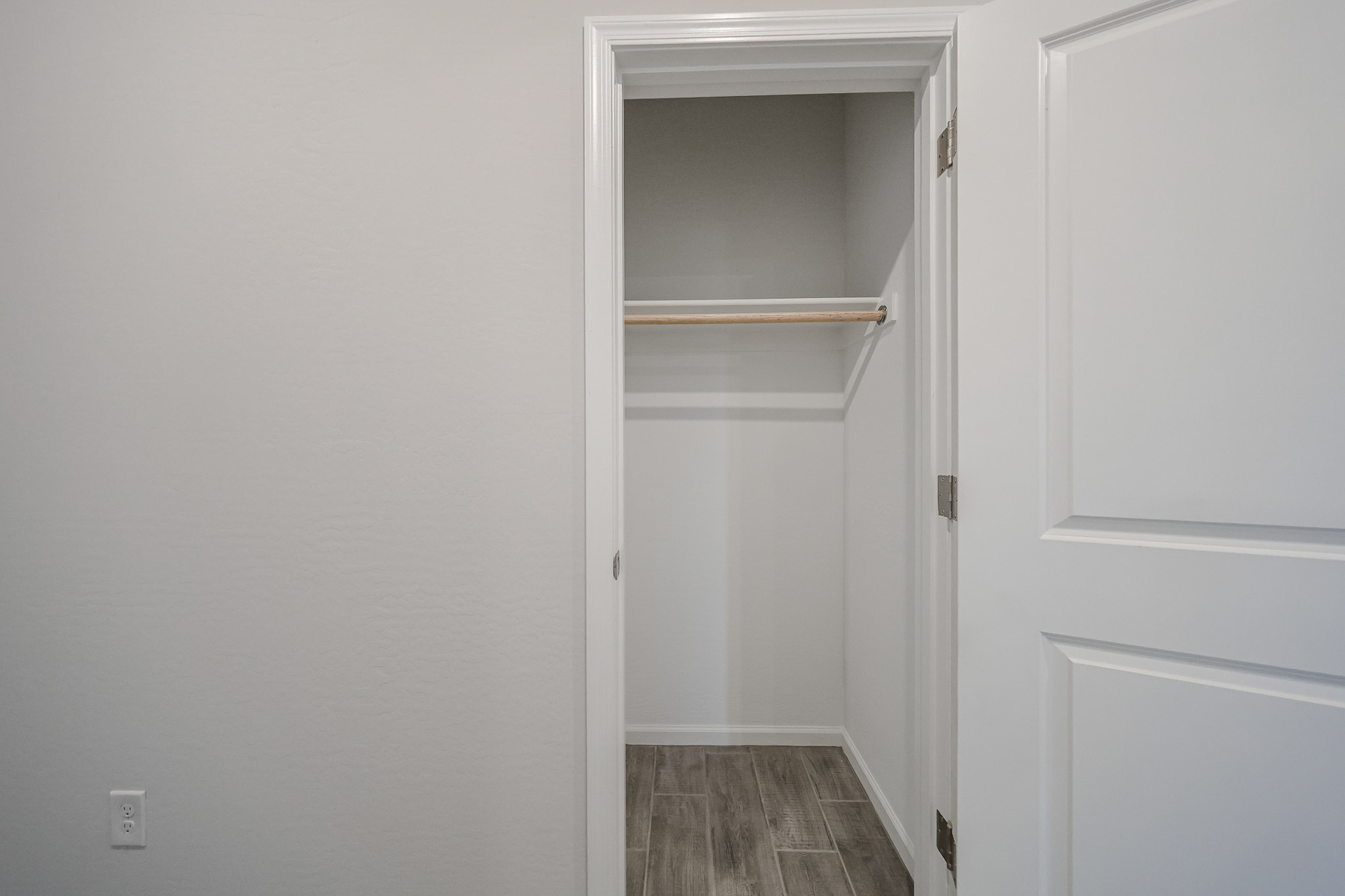 A white door with a shelf.