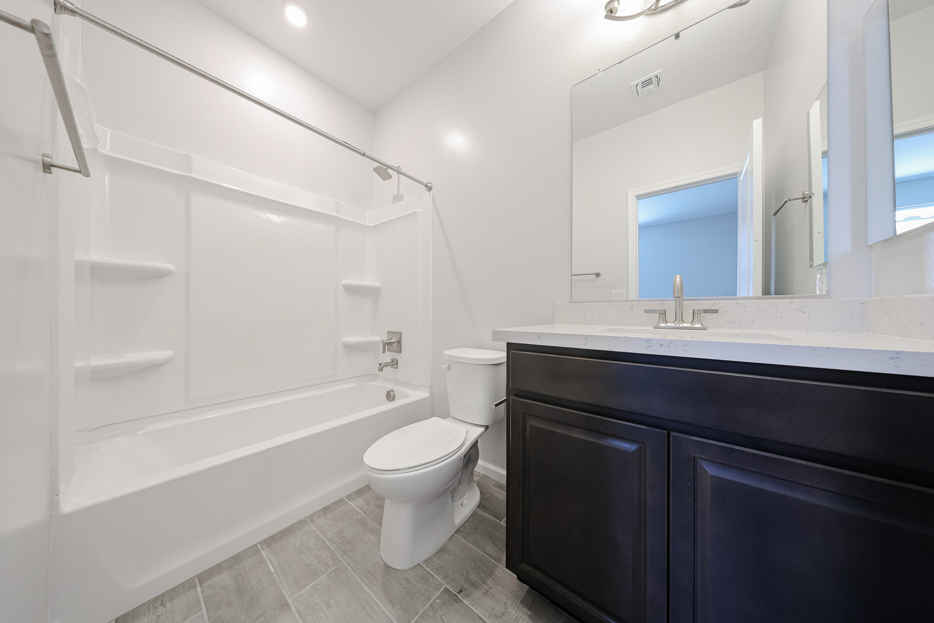 A bathroom with a tub toilet and sink.