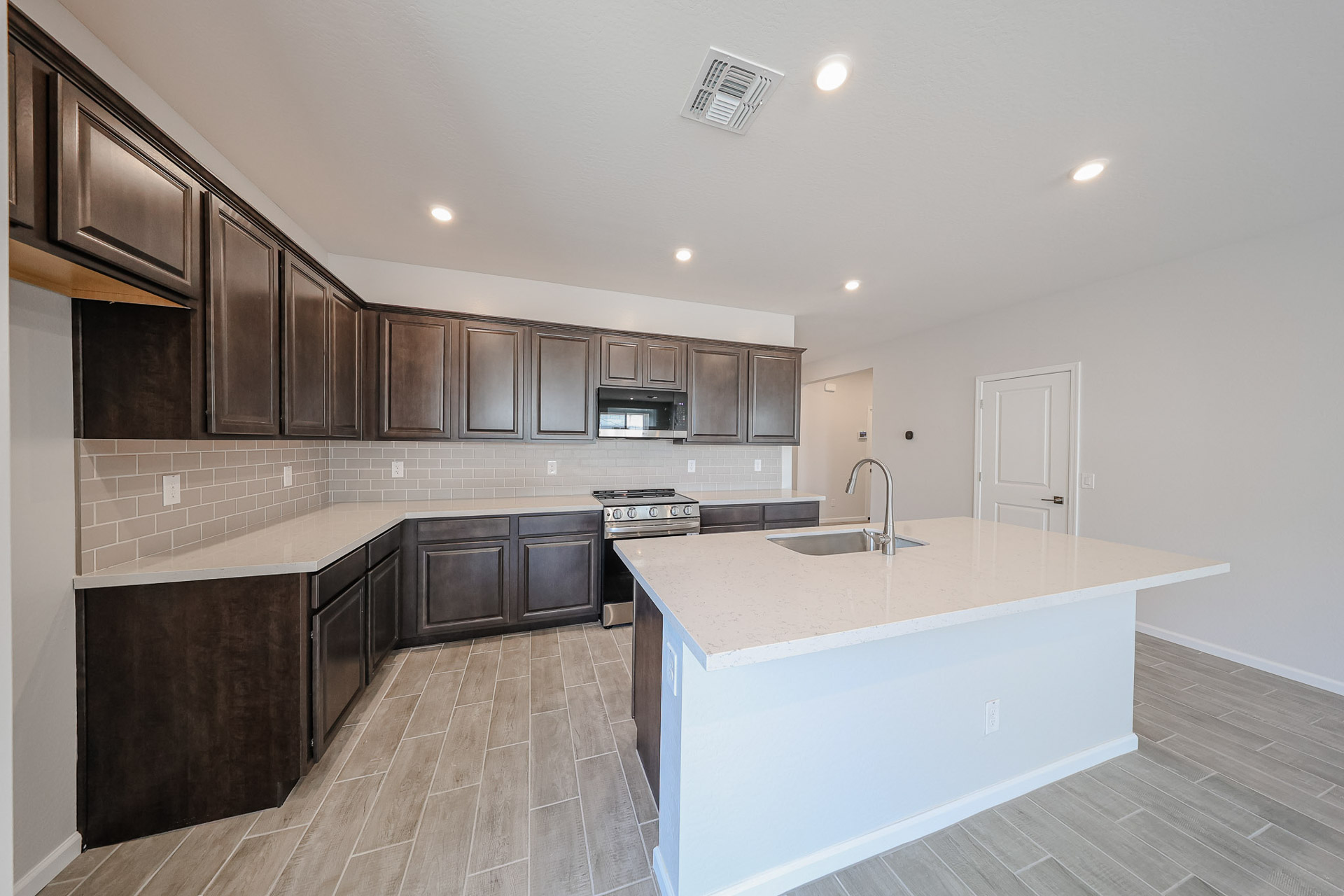 A kitchen with wooden cabinets.