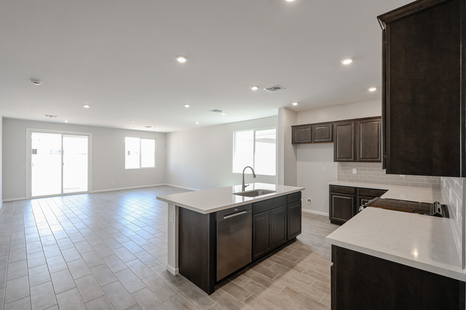 A kitchen with black cabinets.