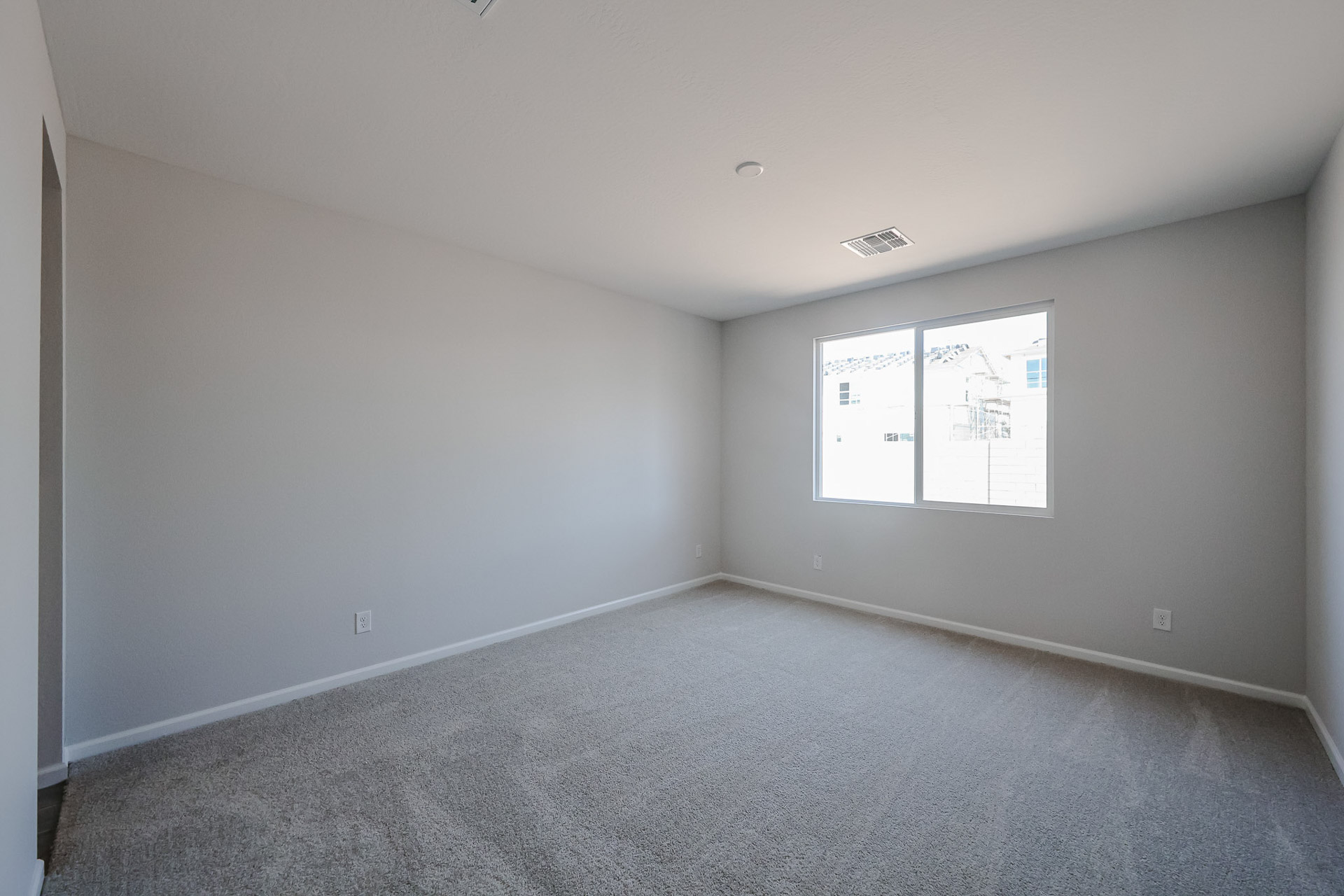 A room with a whiteboard and a white wall.