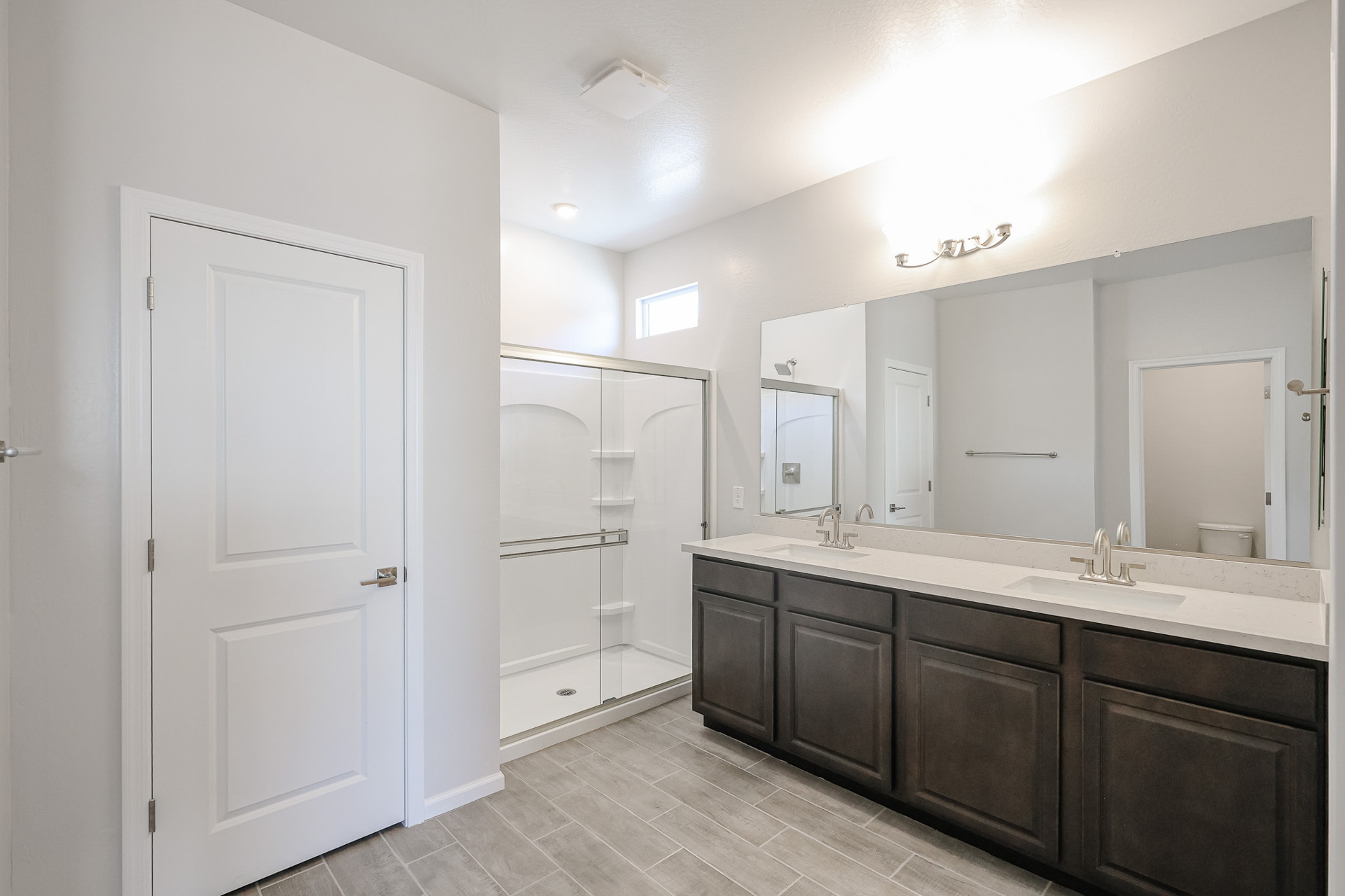 A bathroom with a large mirror.
