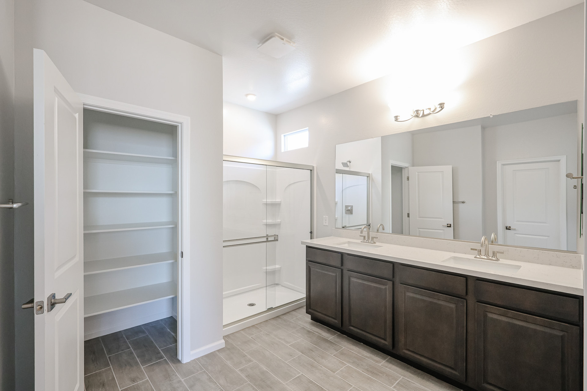 A bathroom with a large mirror.