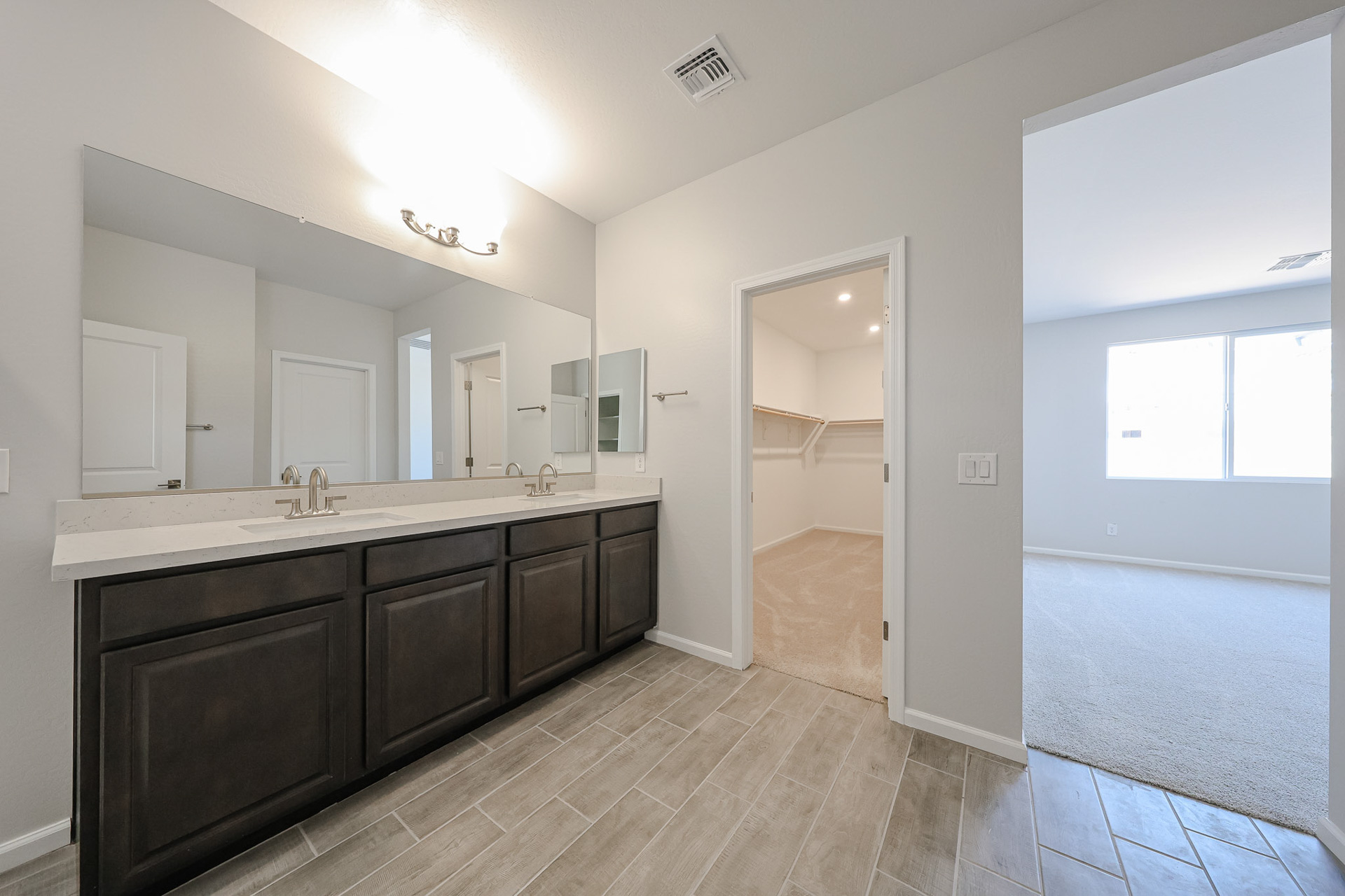 A bathroom with a large mirror.