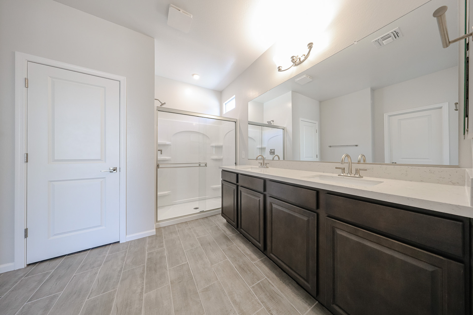 A bathroom with a large mirror.