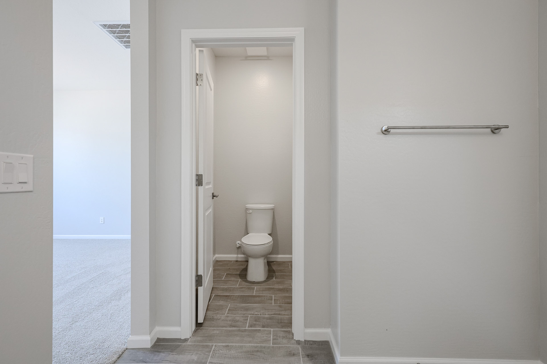 A bathroom with a toilet and a shower unit.