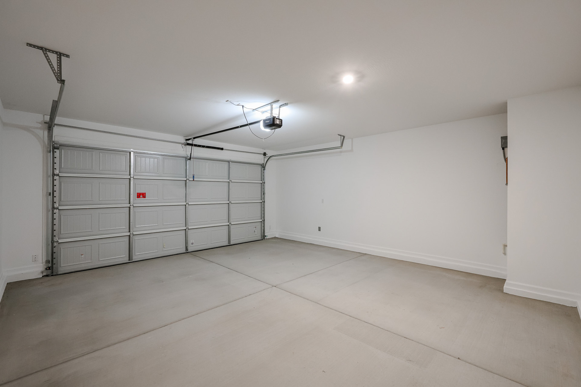 A room with a white wall and a light on the ceiling.