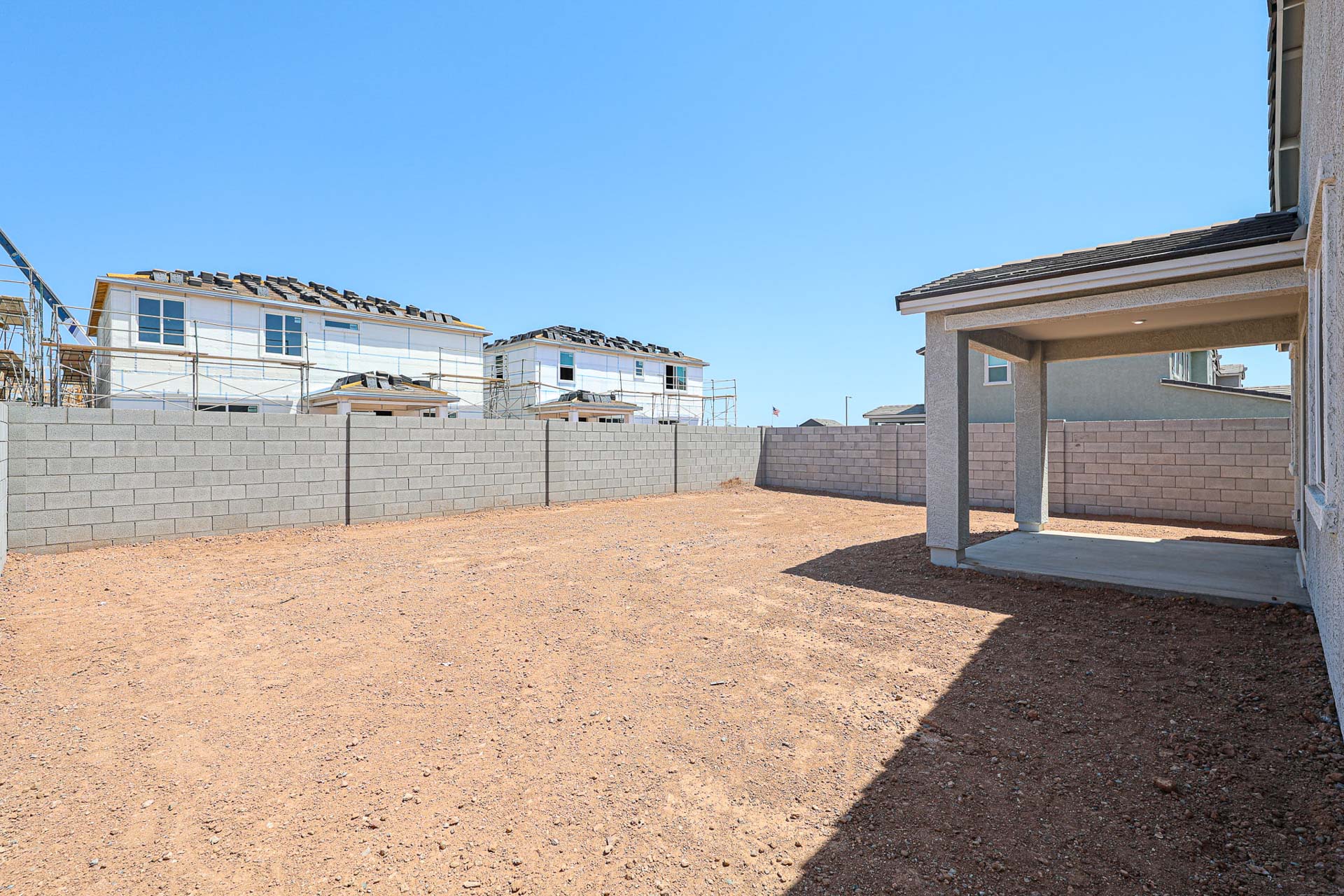 A dirt area with buildings in the background.