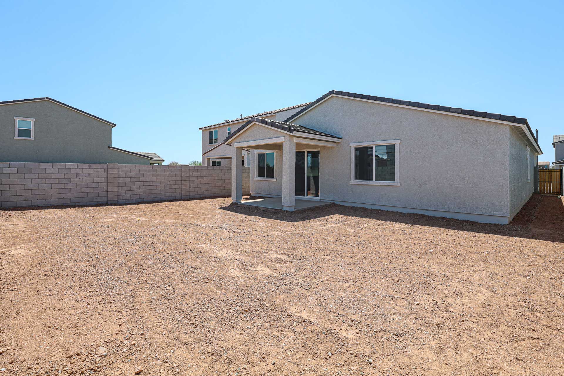 A house with a dirt yard.