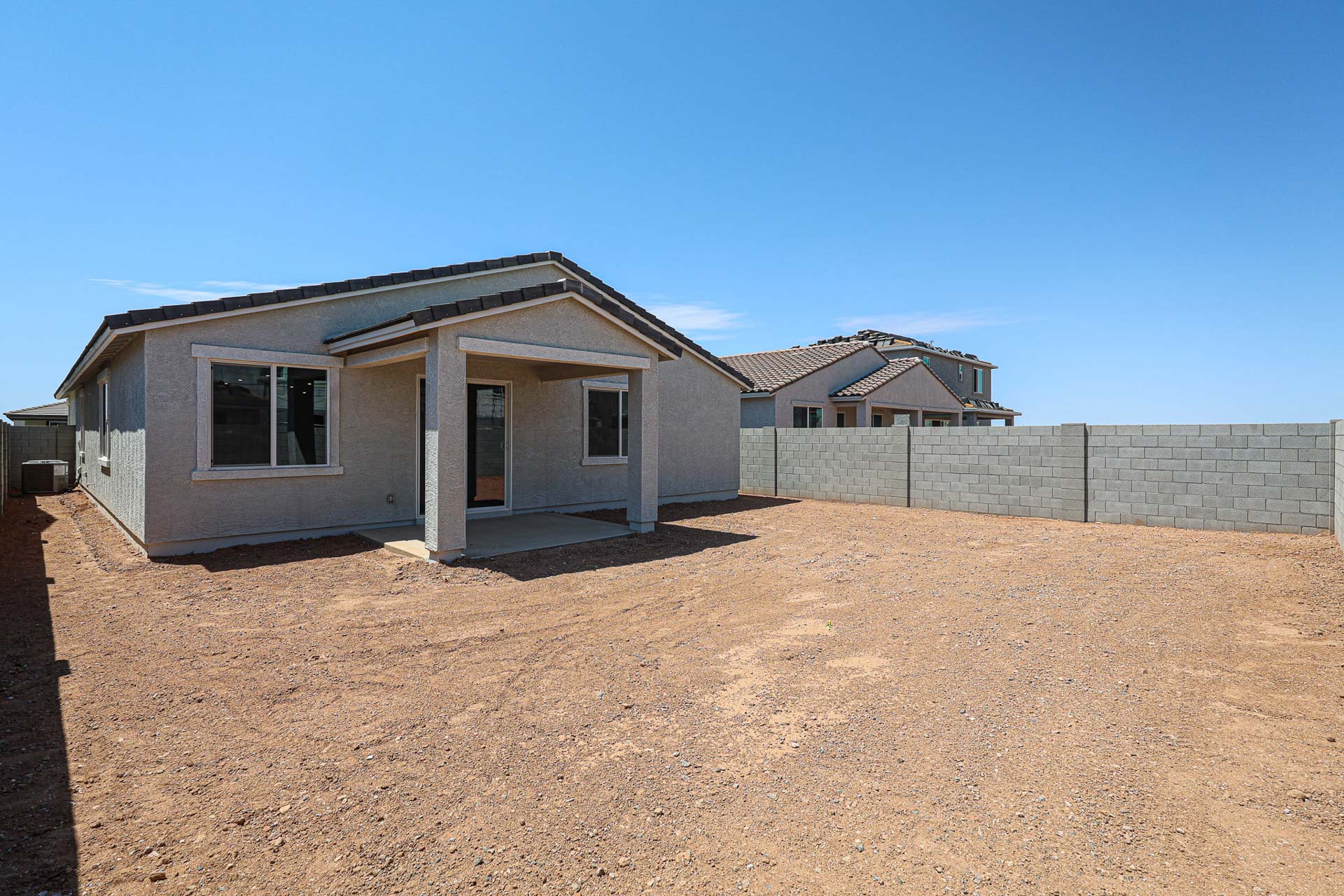 A house with a dirt yard.
