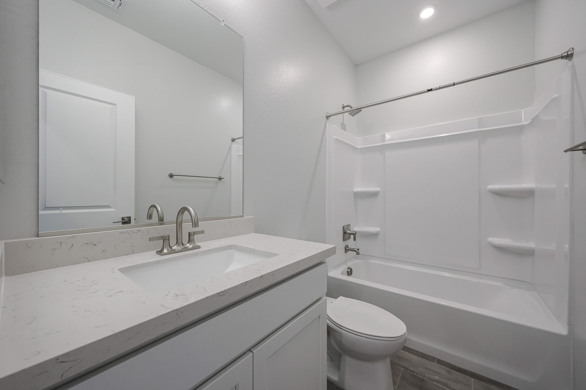 A bathroom with a sink toilet and bathtub.