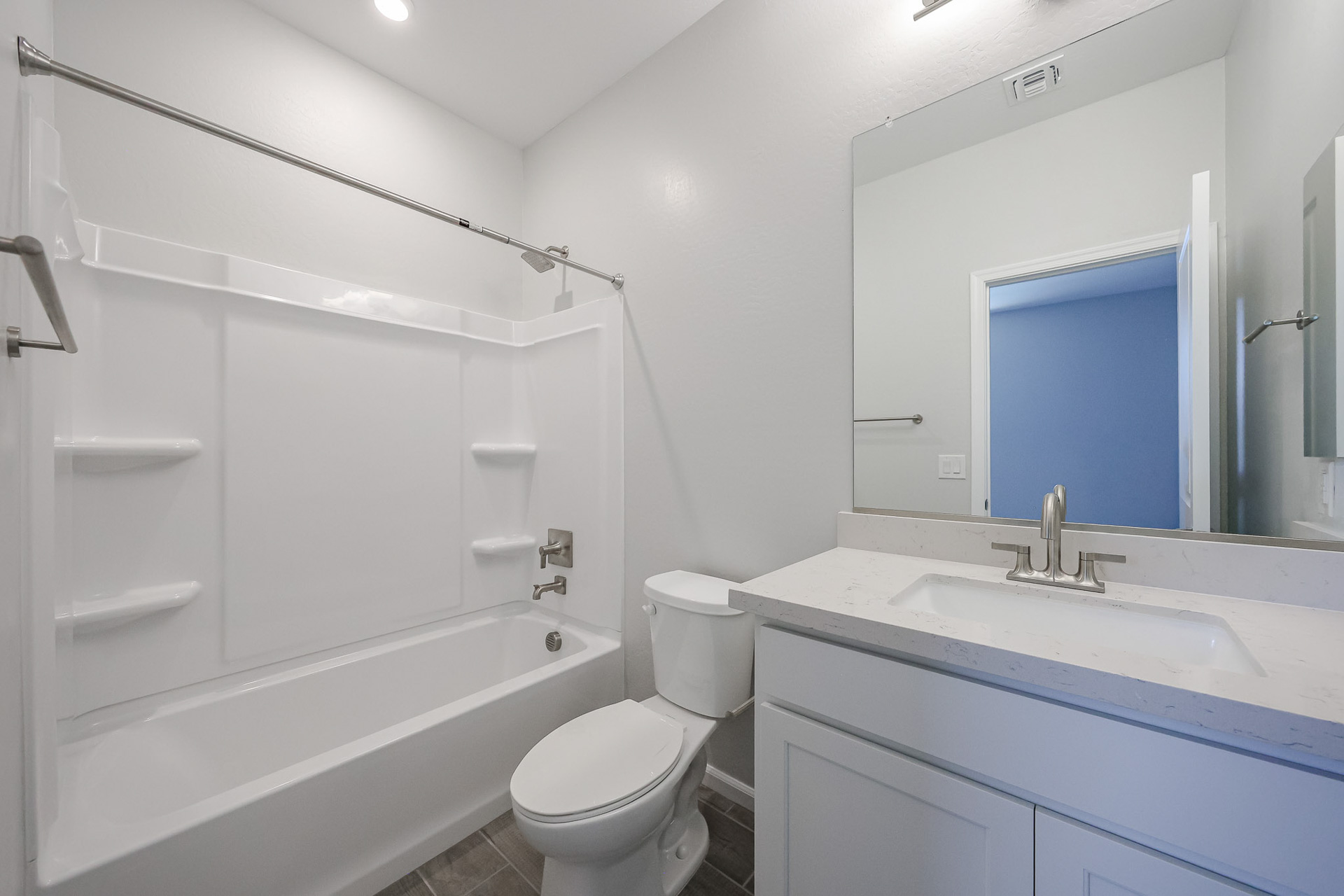 A bathroom with a tub toilet and sink.