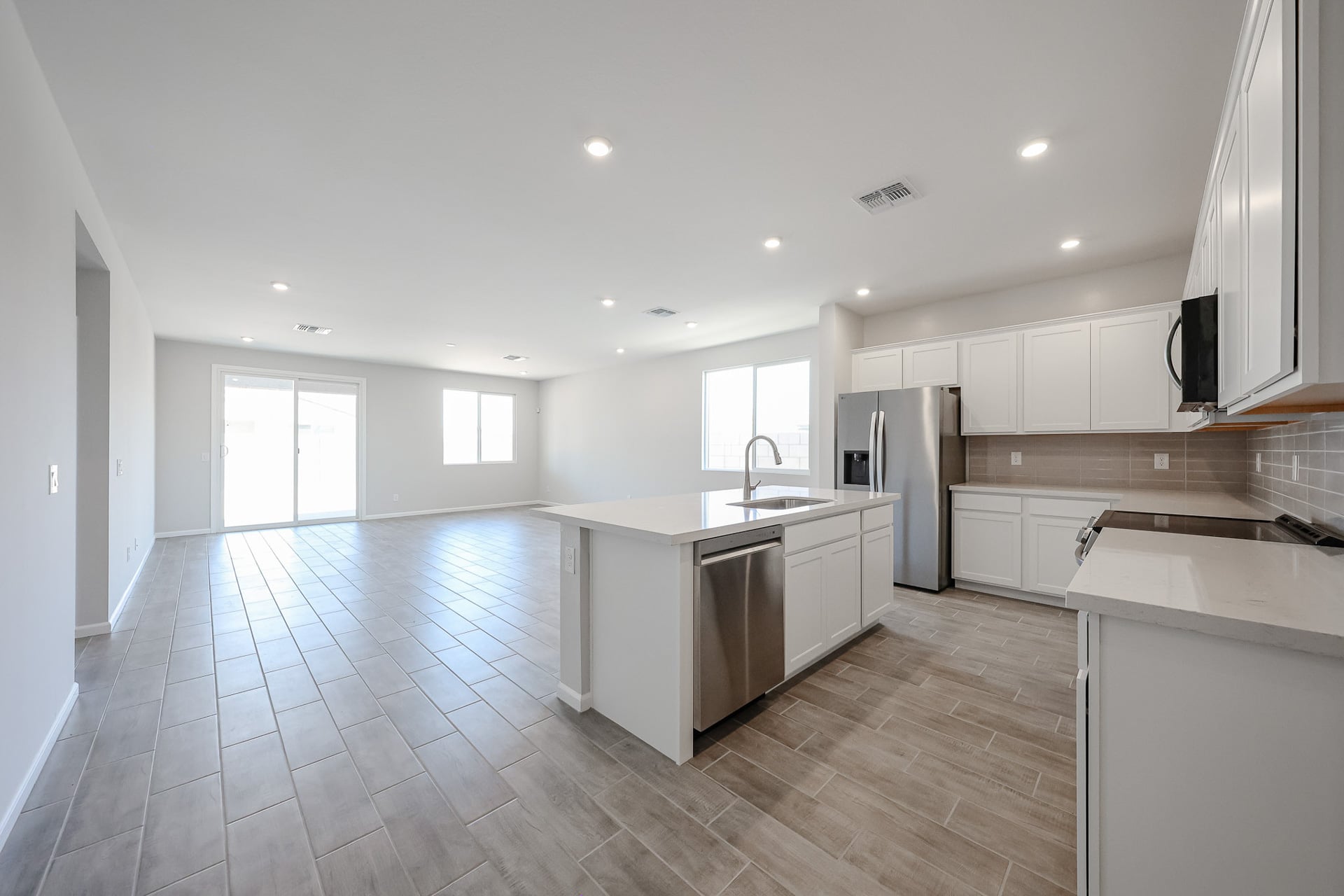 A kitchen with white cabinets.