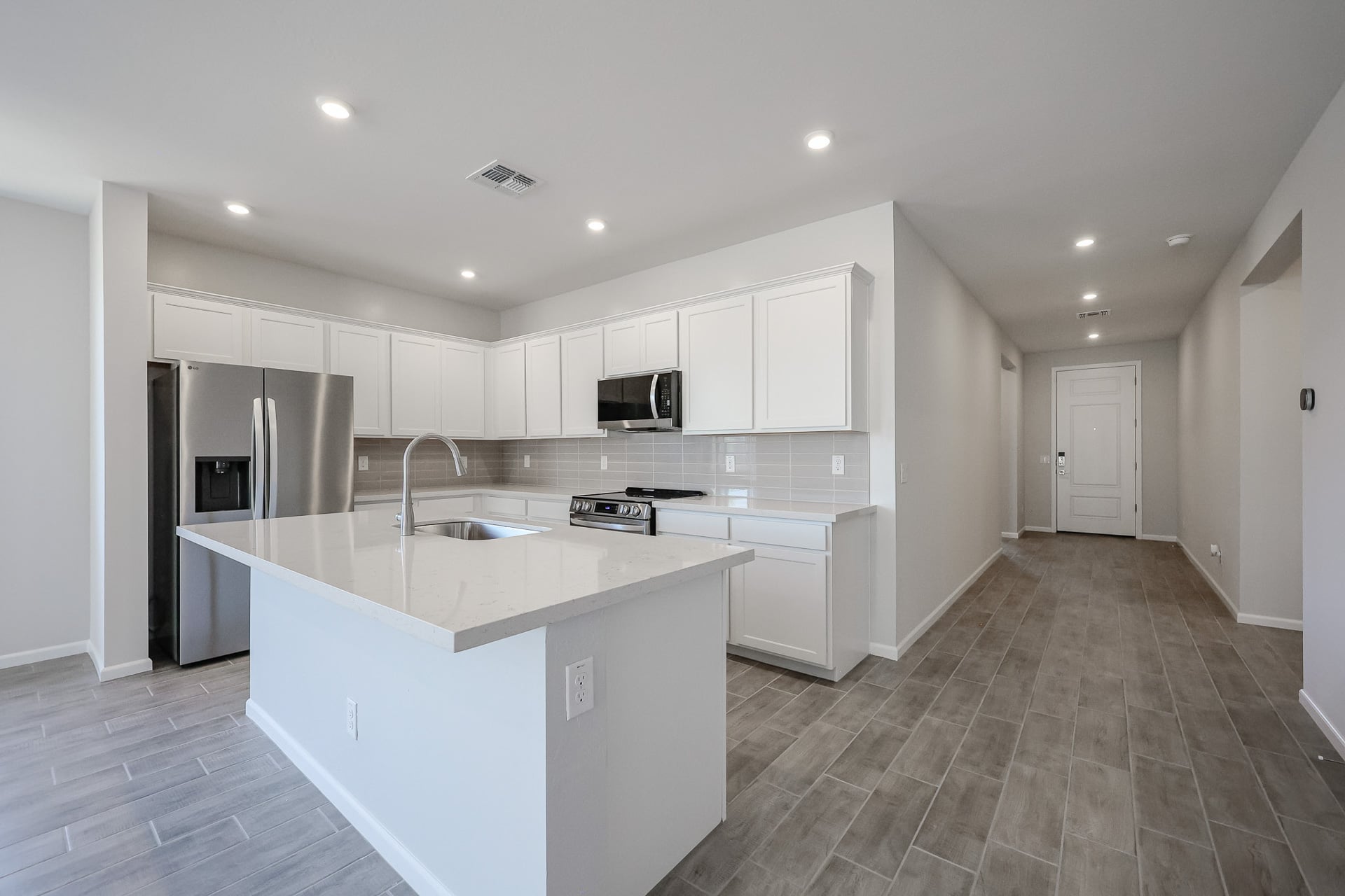A kitchen with white cabinets.