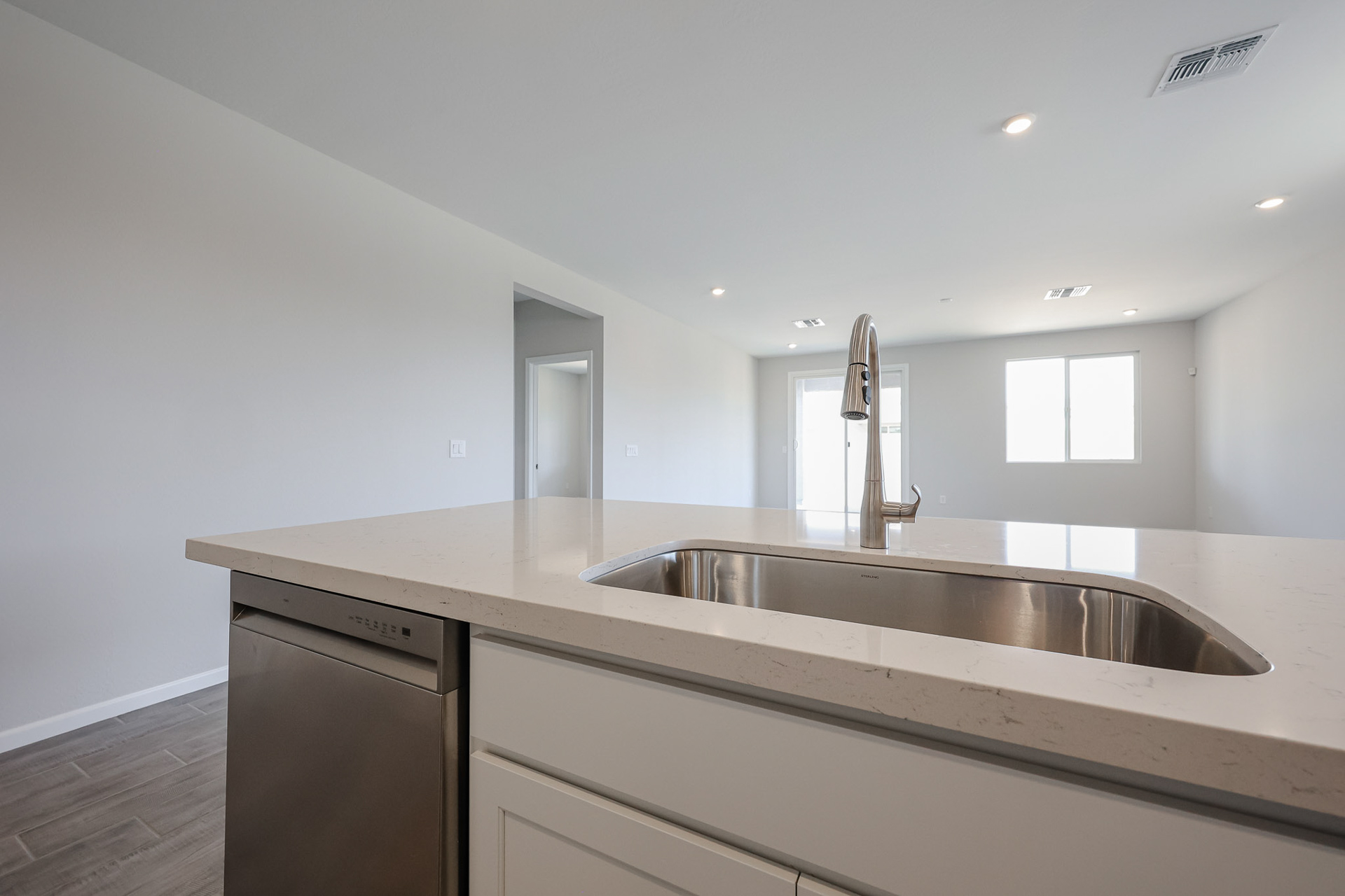 A kitchen with a stainless steel sink.