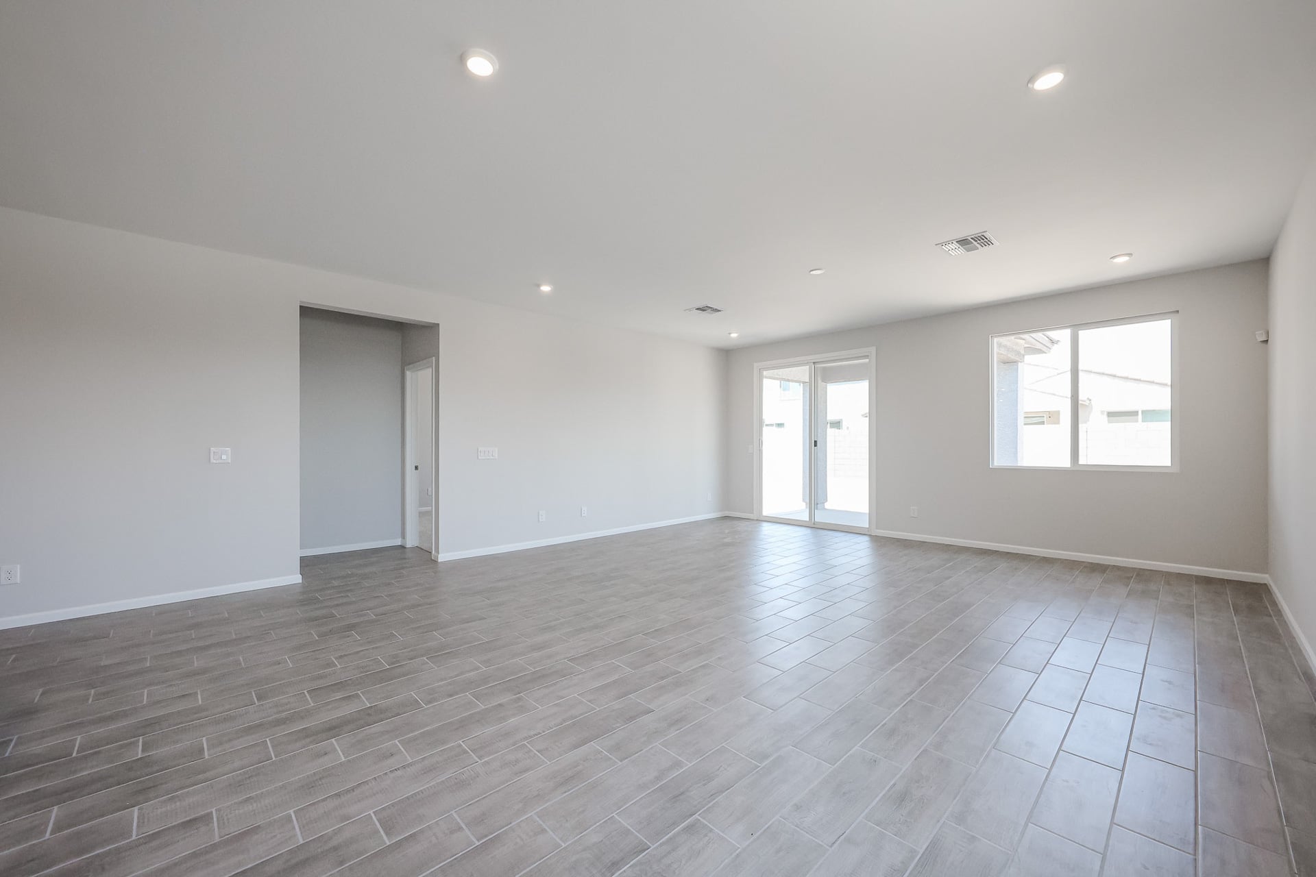 A room with white walls and a wood floor.