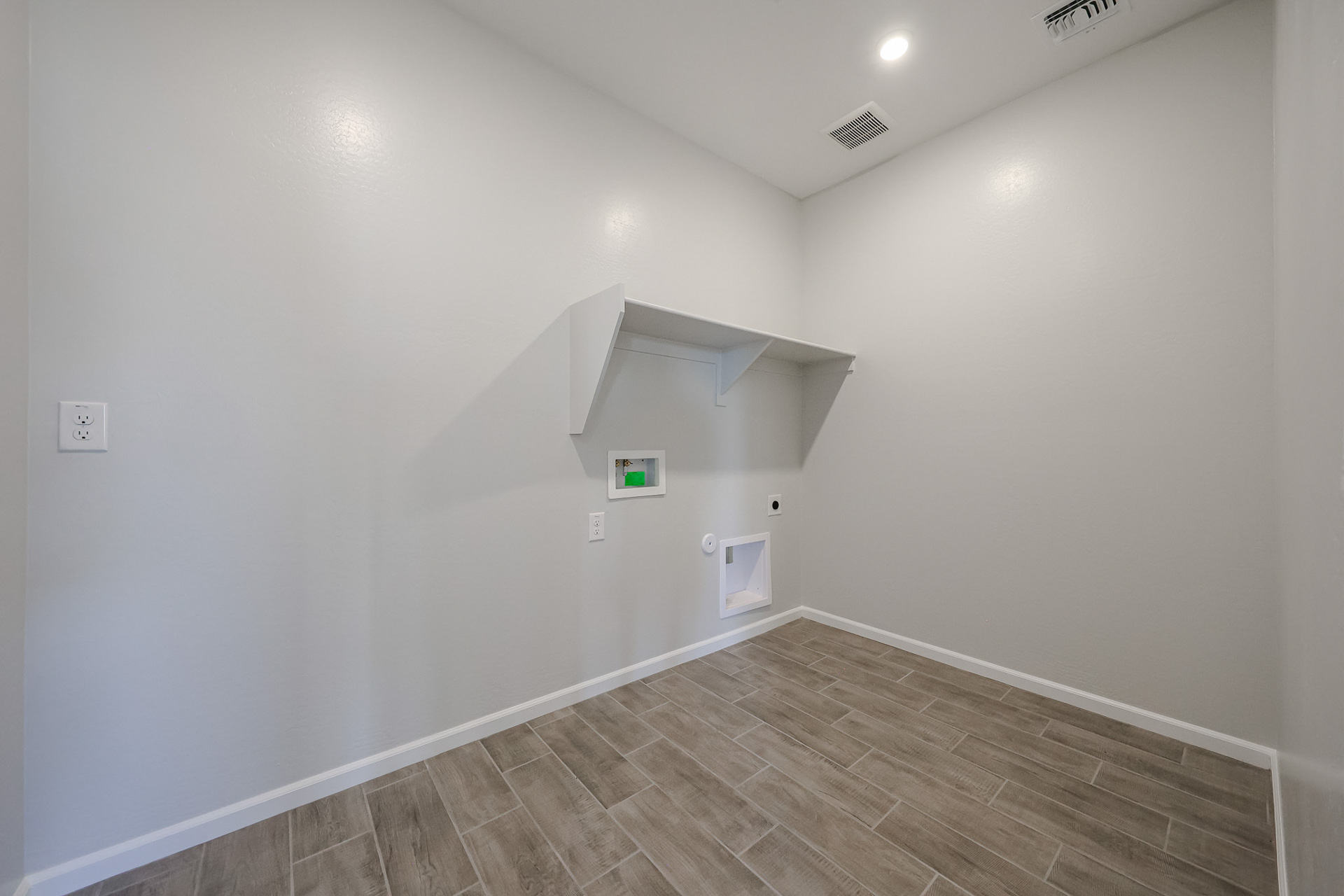 A hallway with a wood floor.
