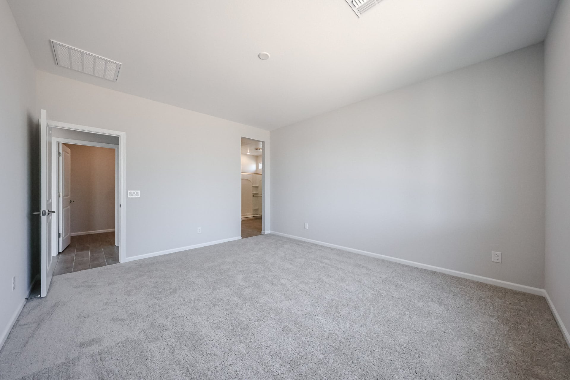 A hallway with white walls.