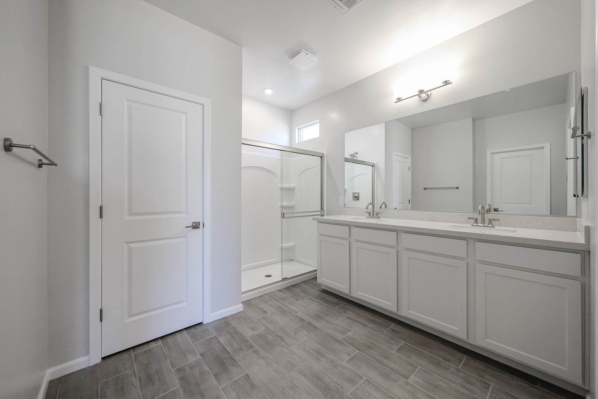 A bathroom with white cabinets.