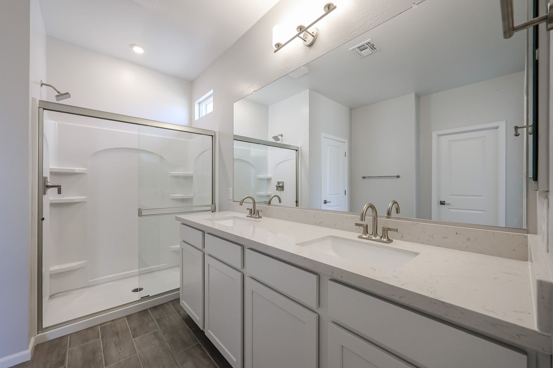 A bathroom with a large mirror.