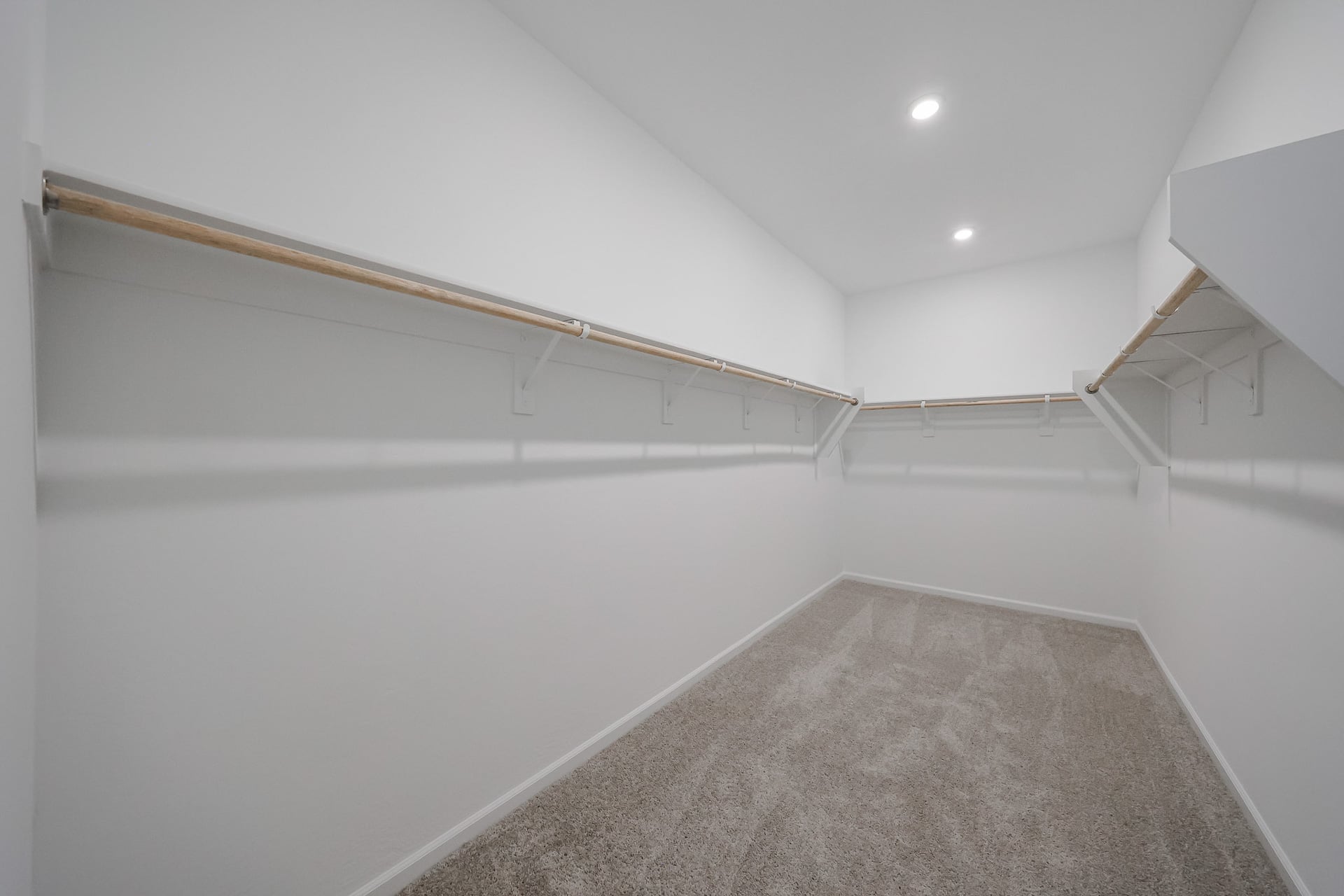 A white hallway with a carpet.