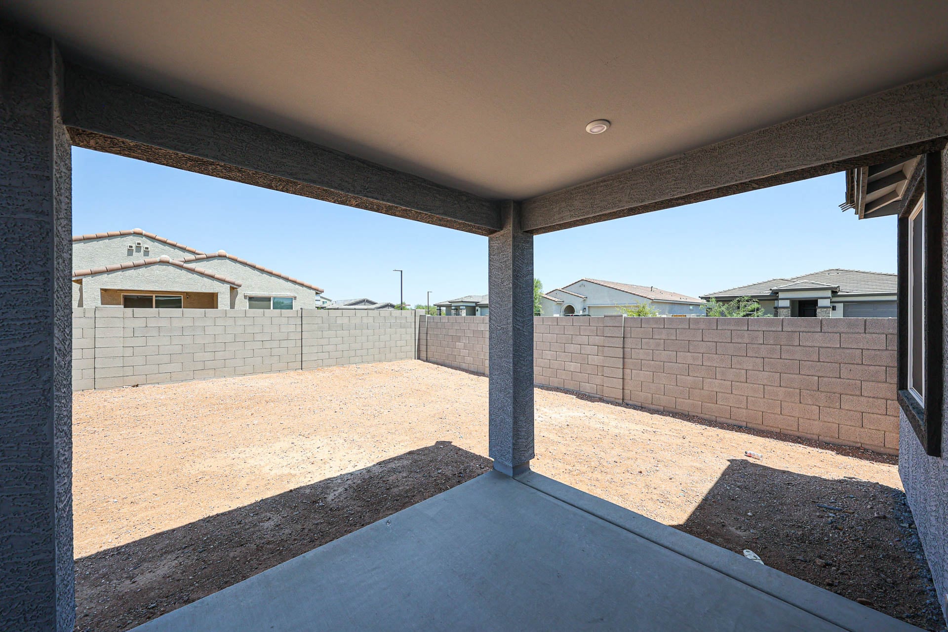 A fenced off area with a brick wall and a brick wall.