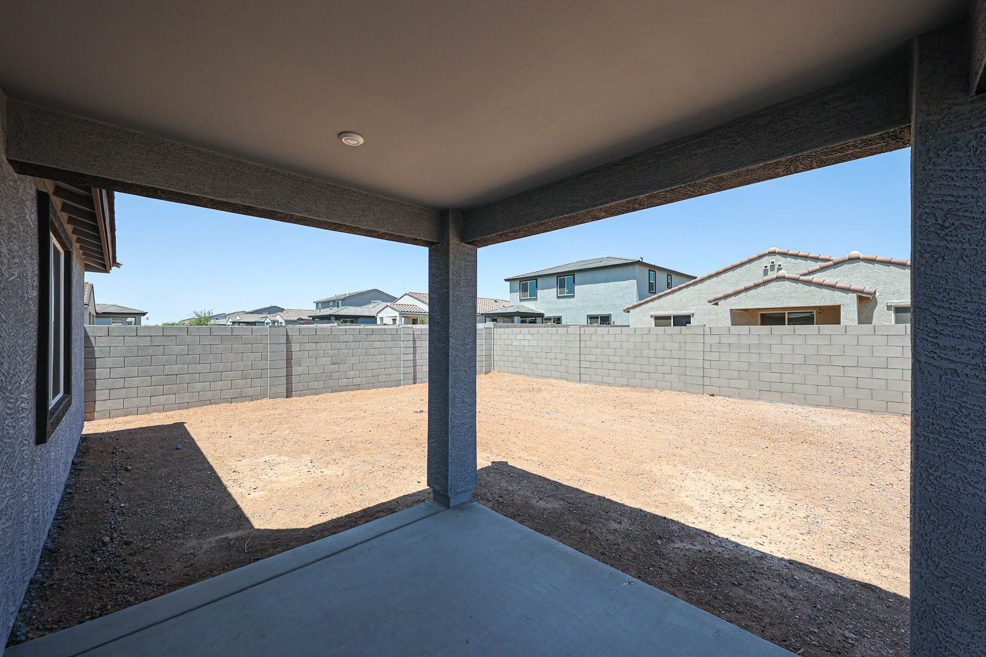 A view of a building through a fence.