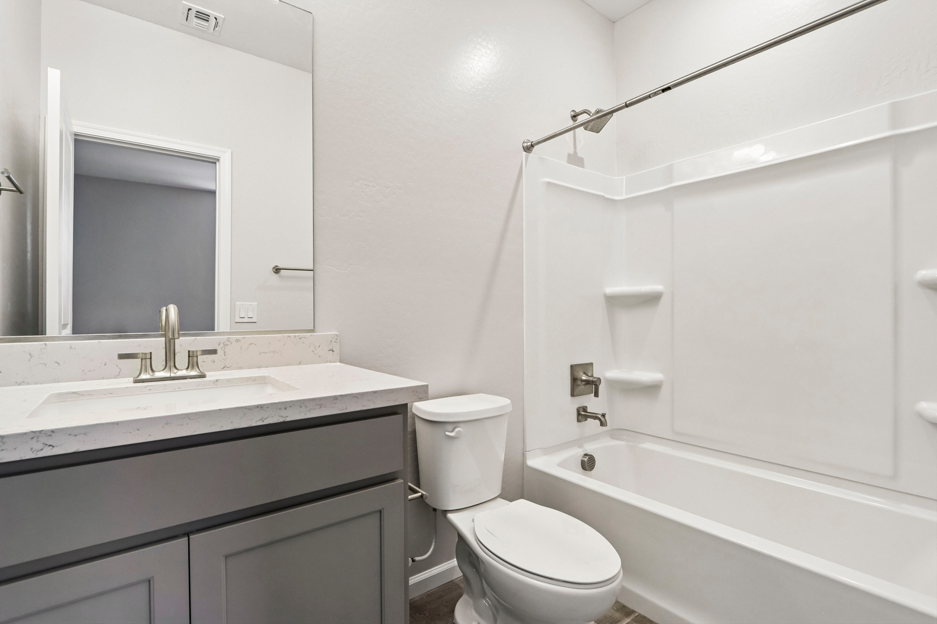 A bathroom with a tub toilet and sink.