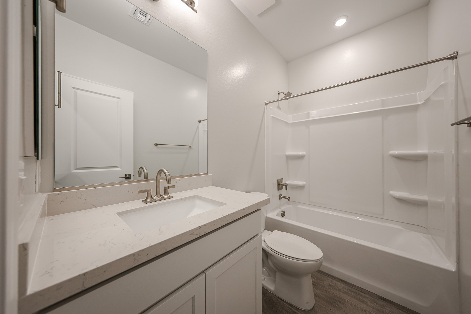 A bathroom with a sink toilet and bathtub.