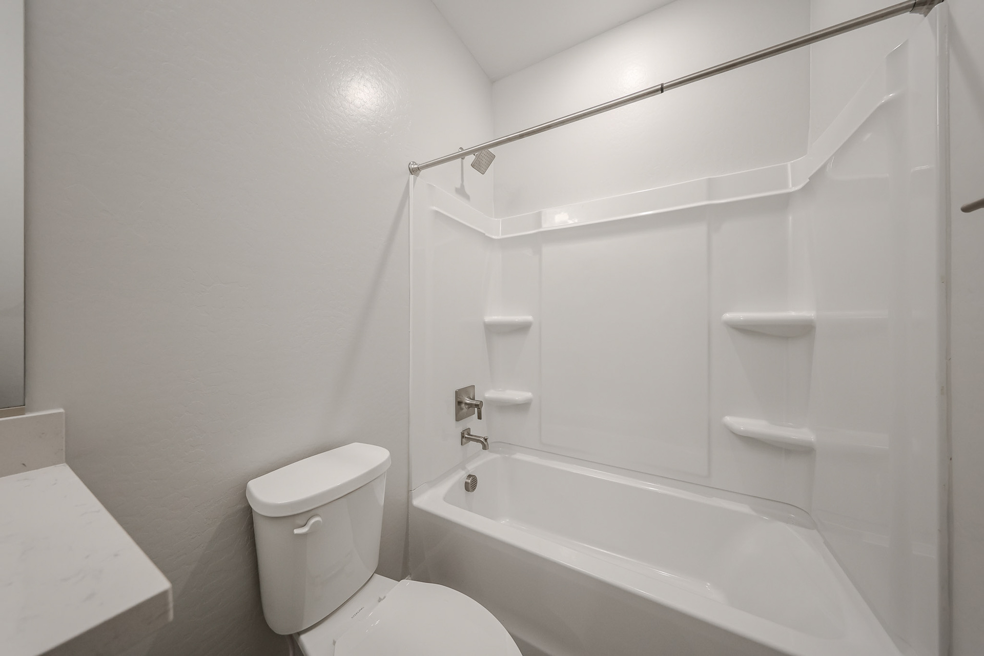 A bathroom with a toilet and bathtub.