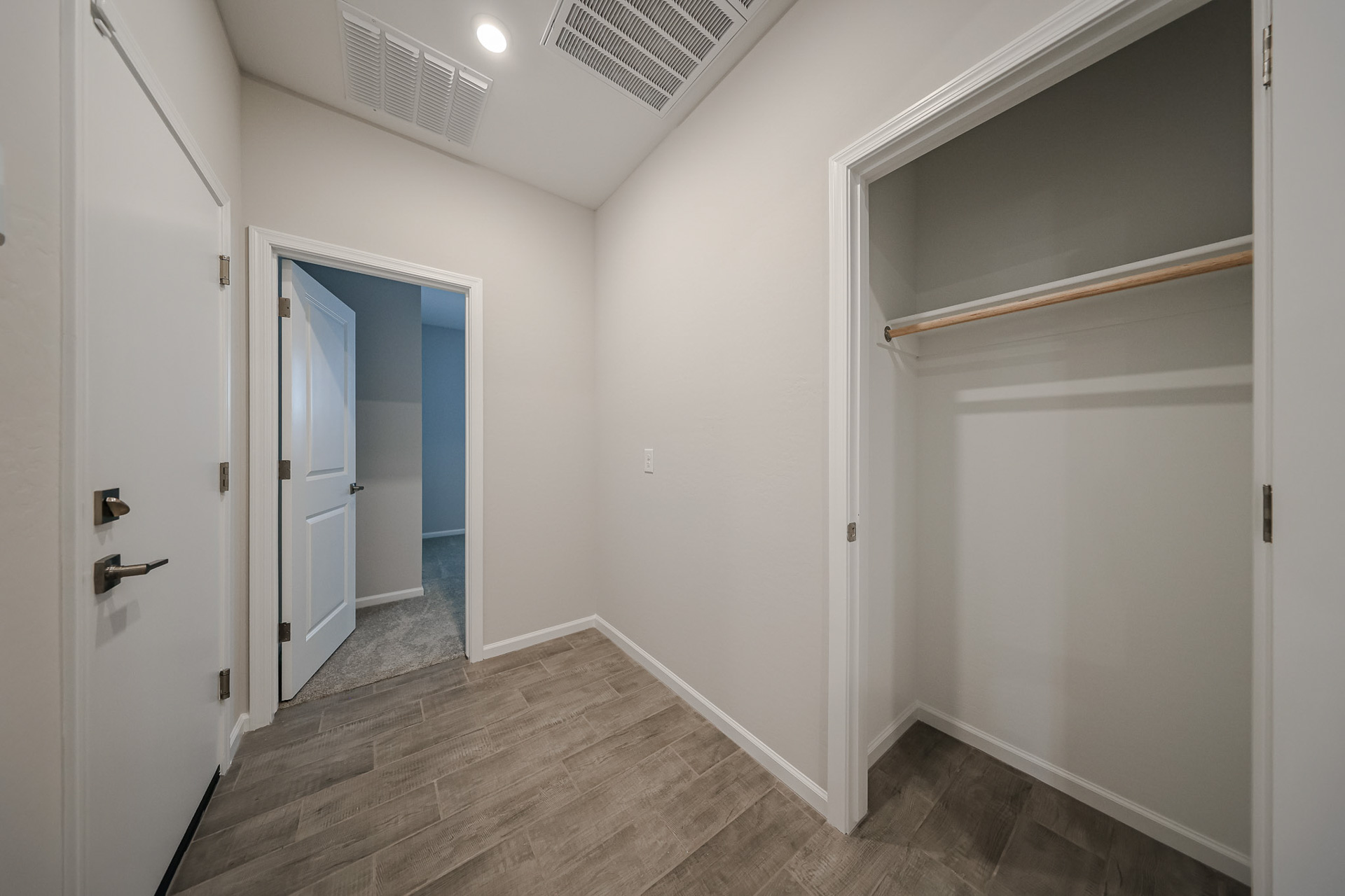 A hallway with white walls.