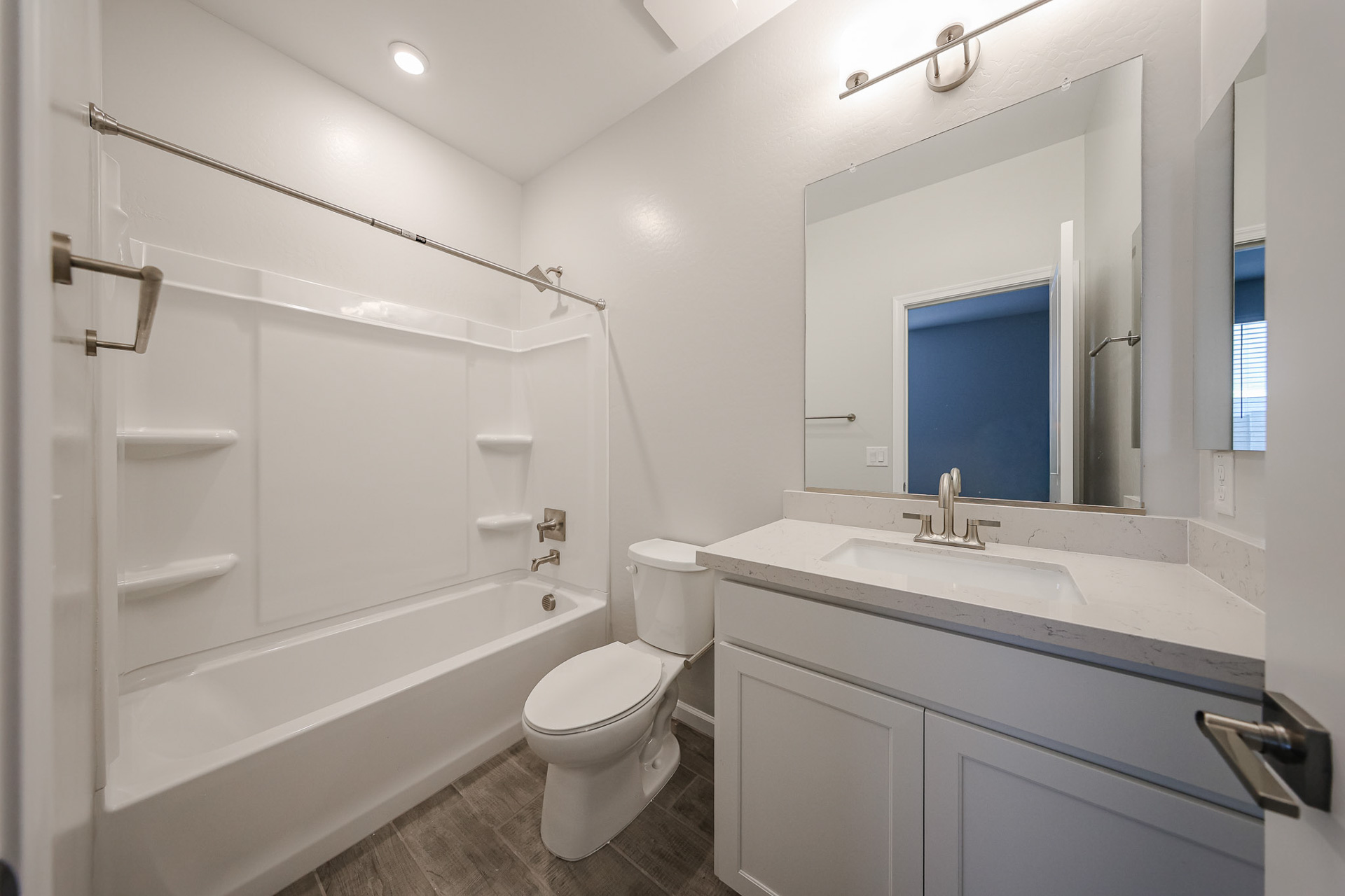 A bathroom with a tub sink and toilet.
