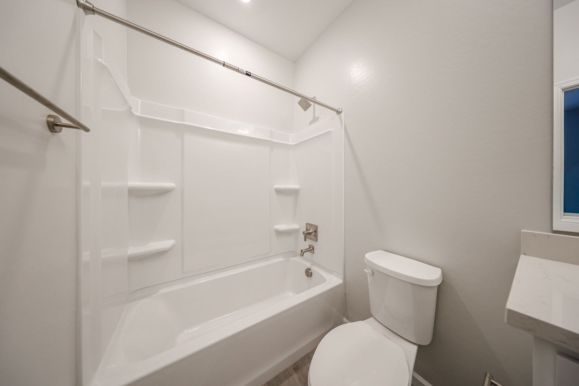 A bathroom with a shower and toilet.