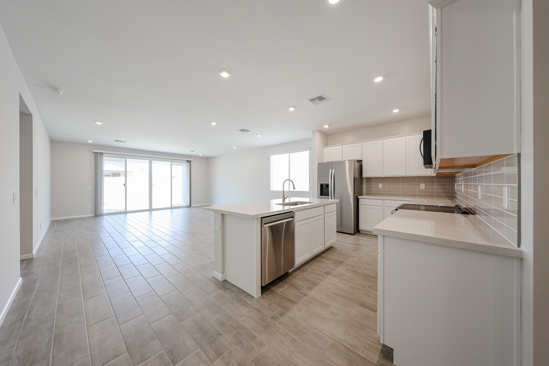A kitchen with white cabinets.