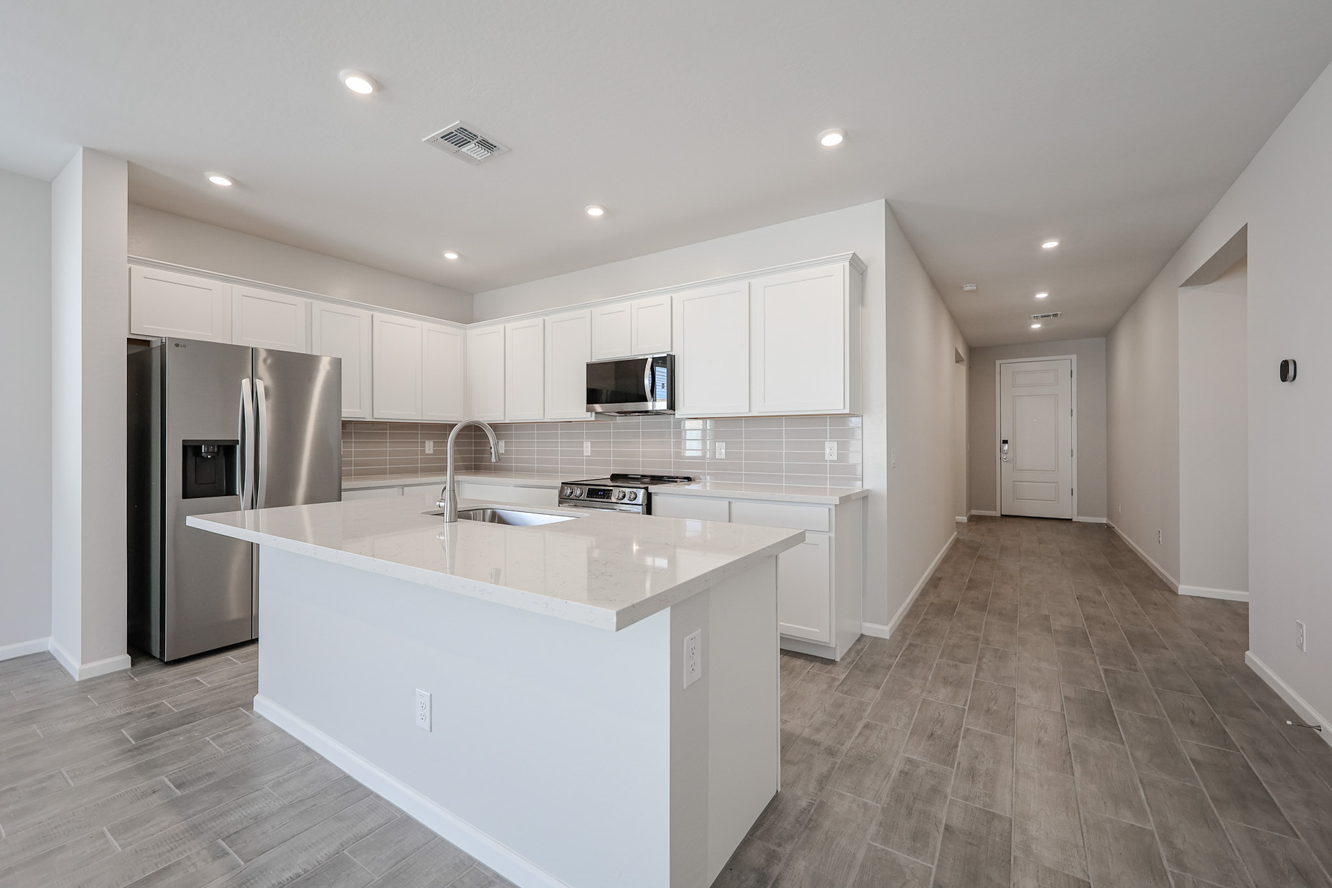 A kitchen with white cabinets.