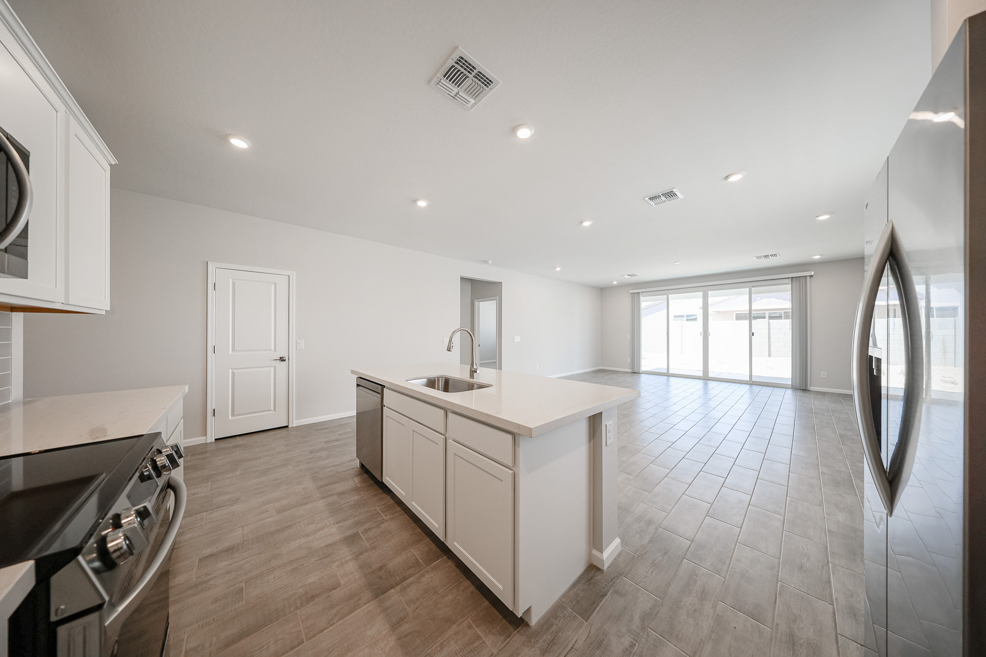 A kitchen with white cabinets.