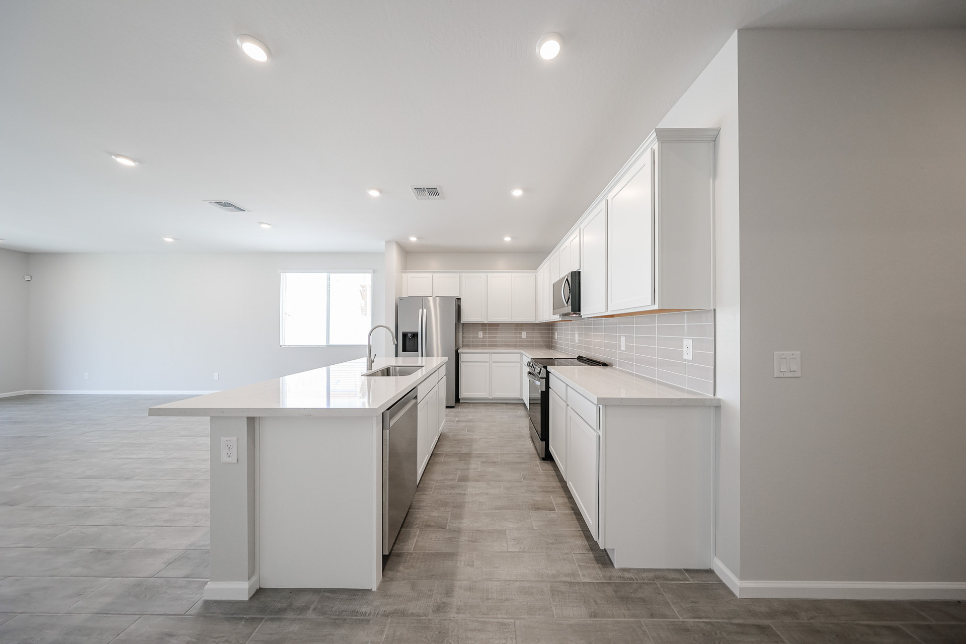 A kitchen with white cabinets.