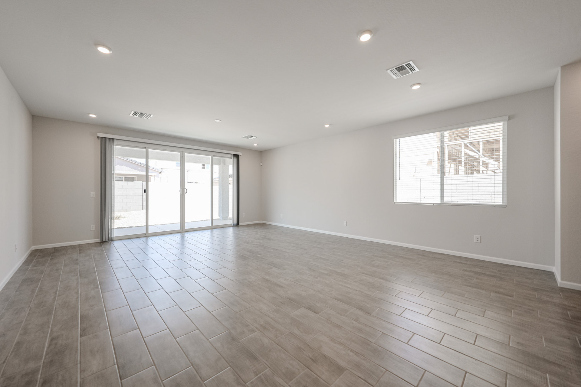 A room with a wood floor and a tile floor.