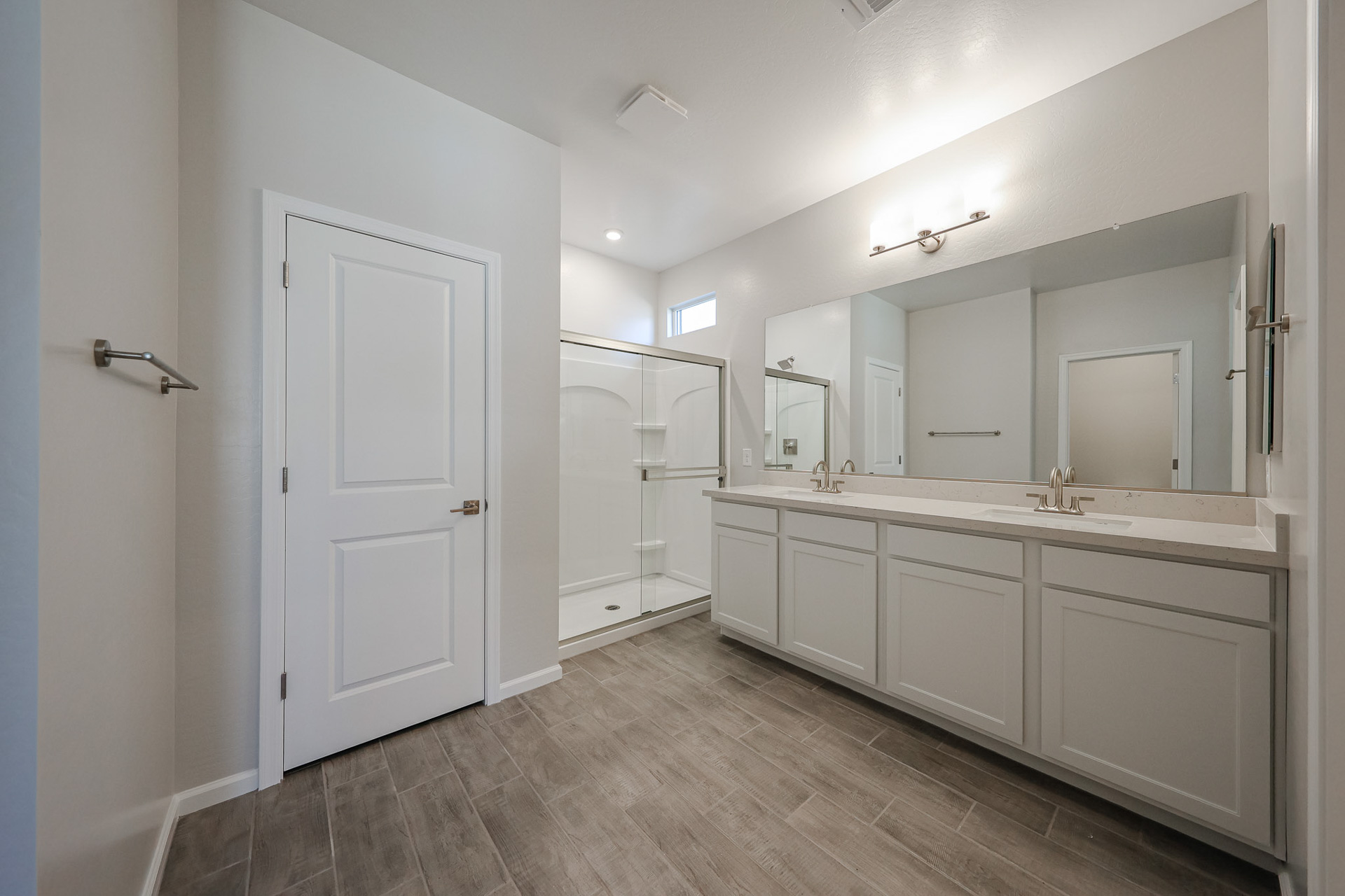 A bathroom with white cabinets.