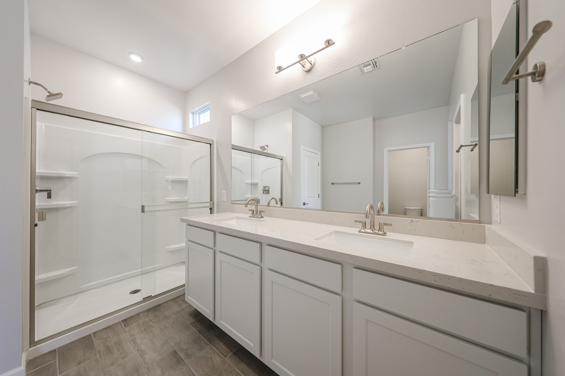 A bathroom with a large mirror.